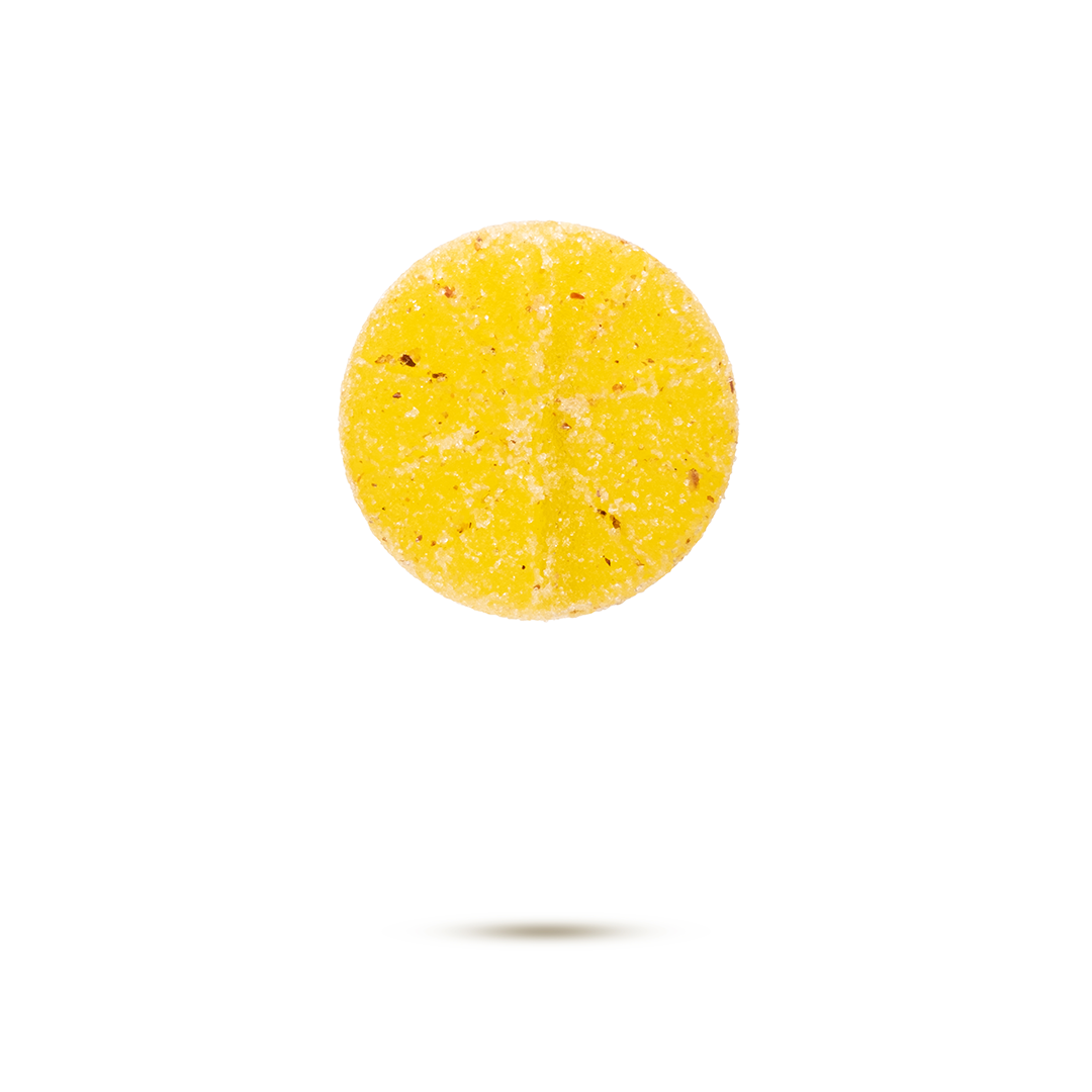 A round yellow candy or lozenge with sugar coating, floating above a slight shadow on a white background.