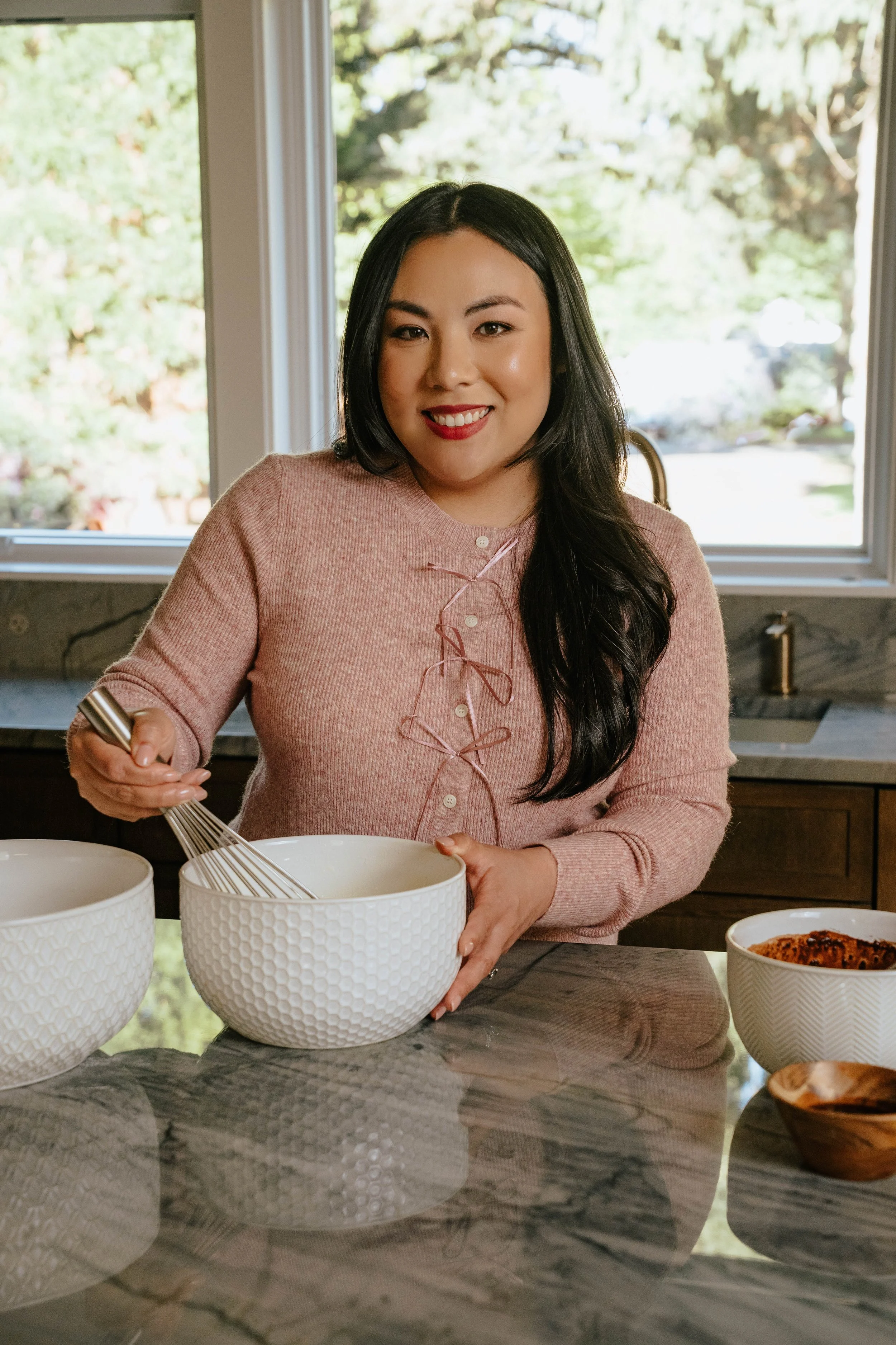 woman with dark hair whisking cake batter