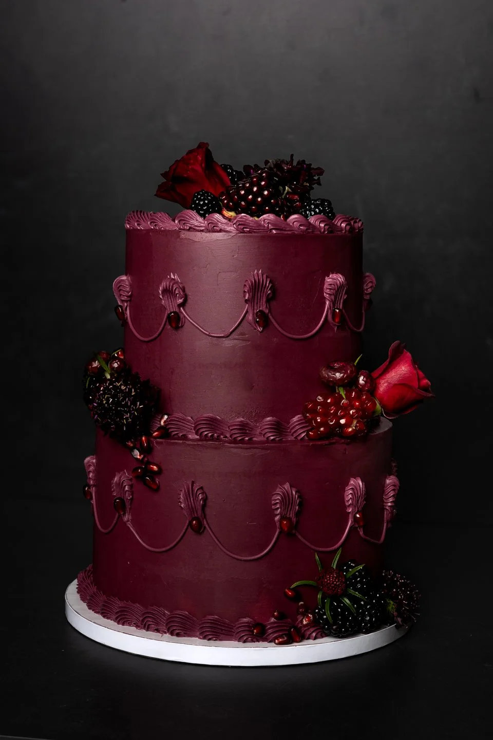 custom two tiered birthday cake in deep wine color using vintage piping, fresh pomegranates, blackberries, and edible flowers in Eugene OR