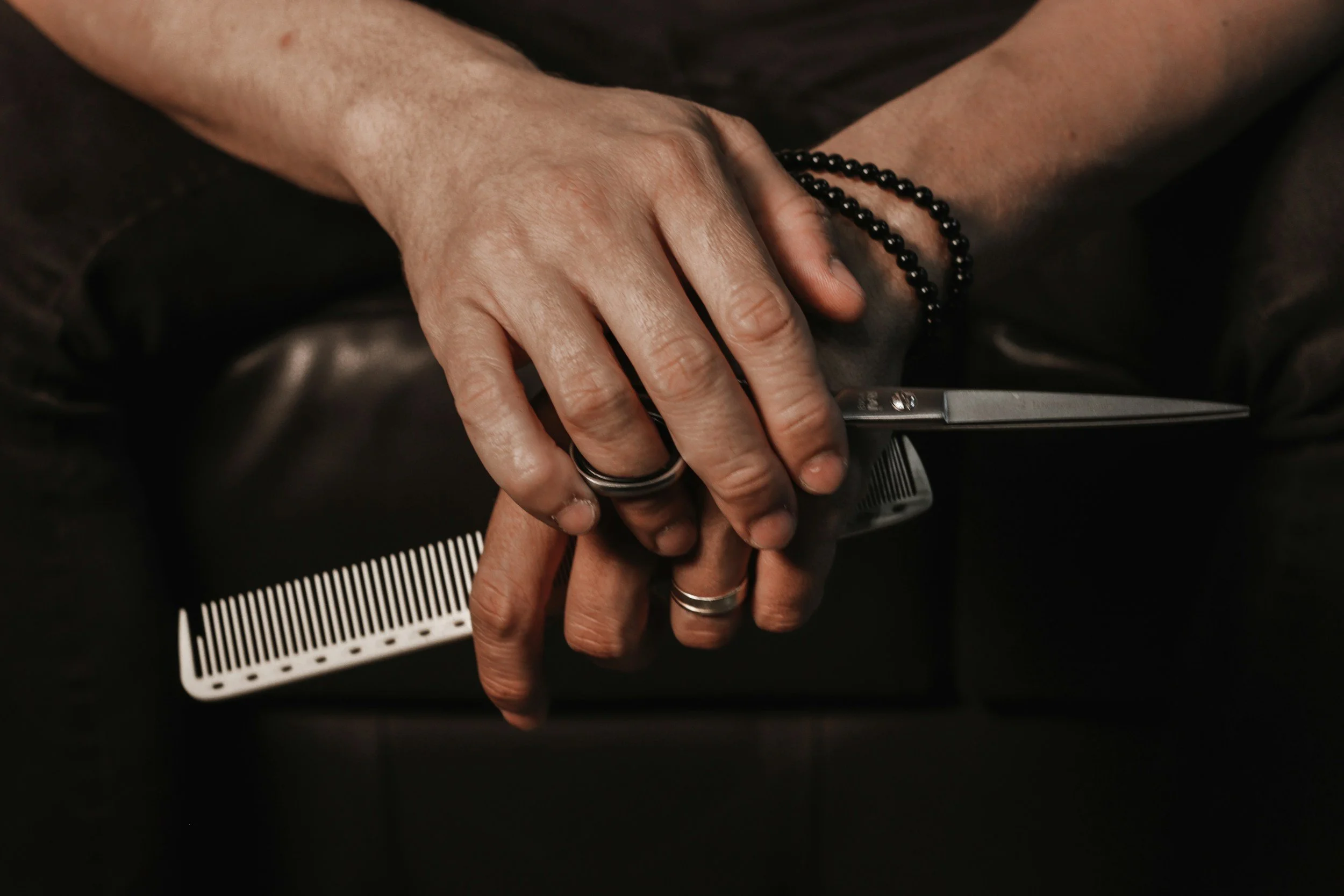 Hairstylist holding scissors and comb
