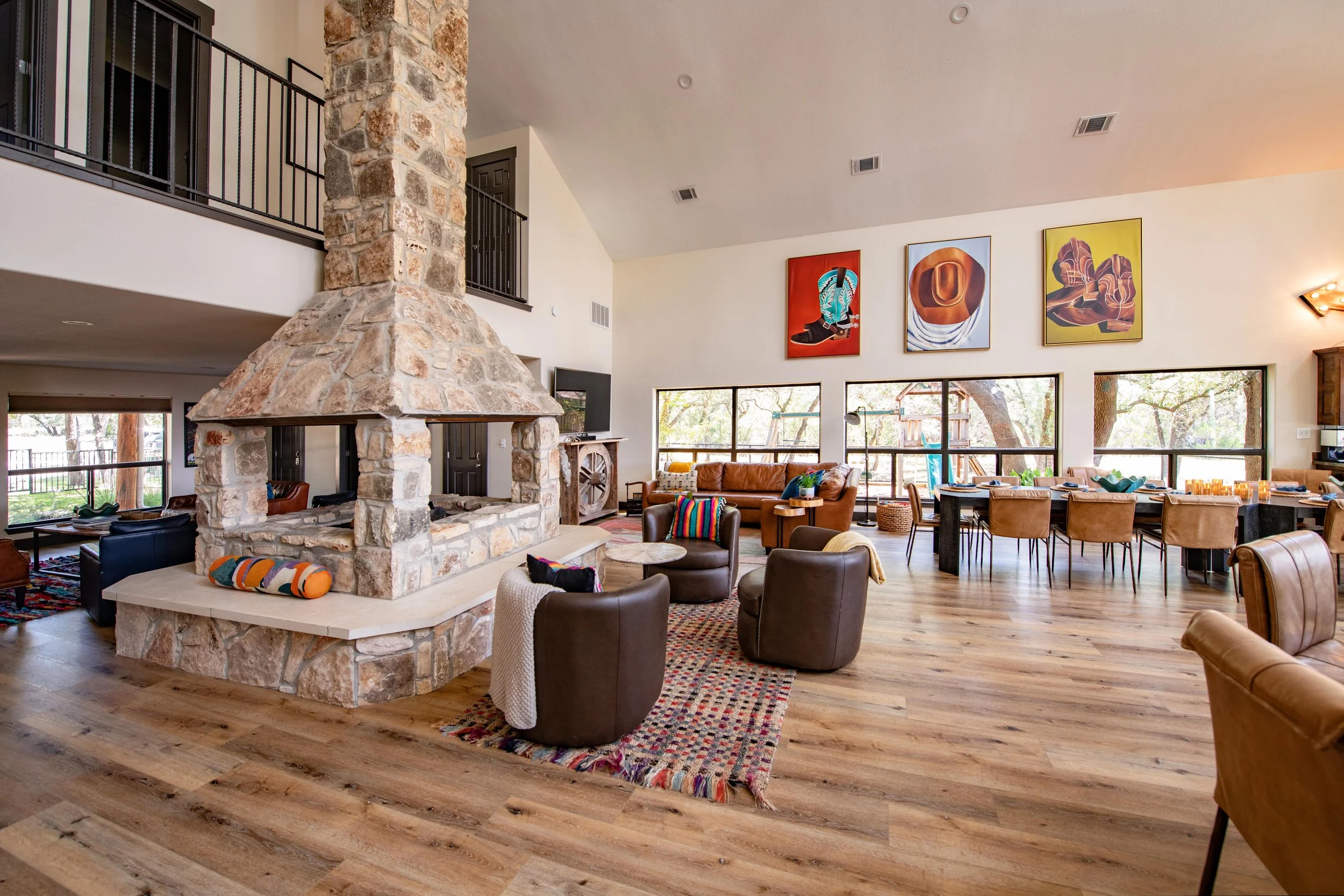 Outside view of large stone house with gates and trees surrounding it in Wimberley, TX