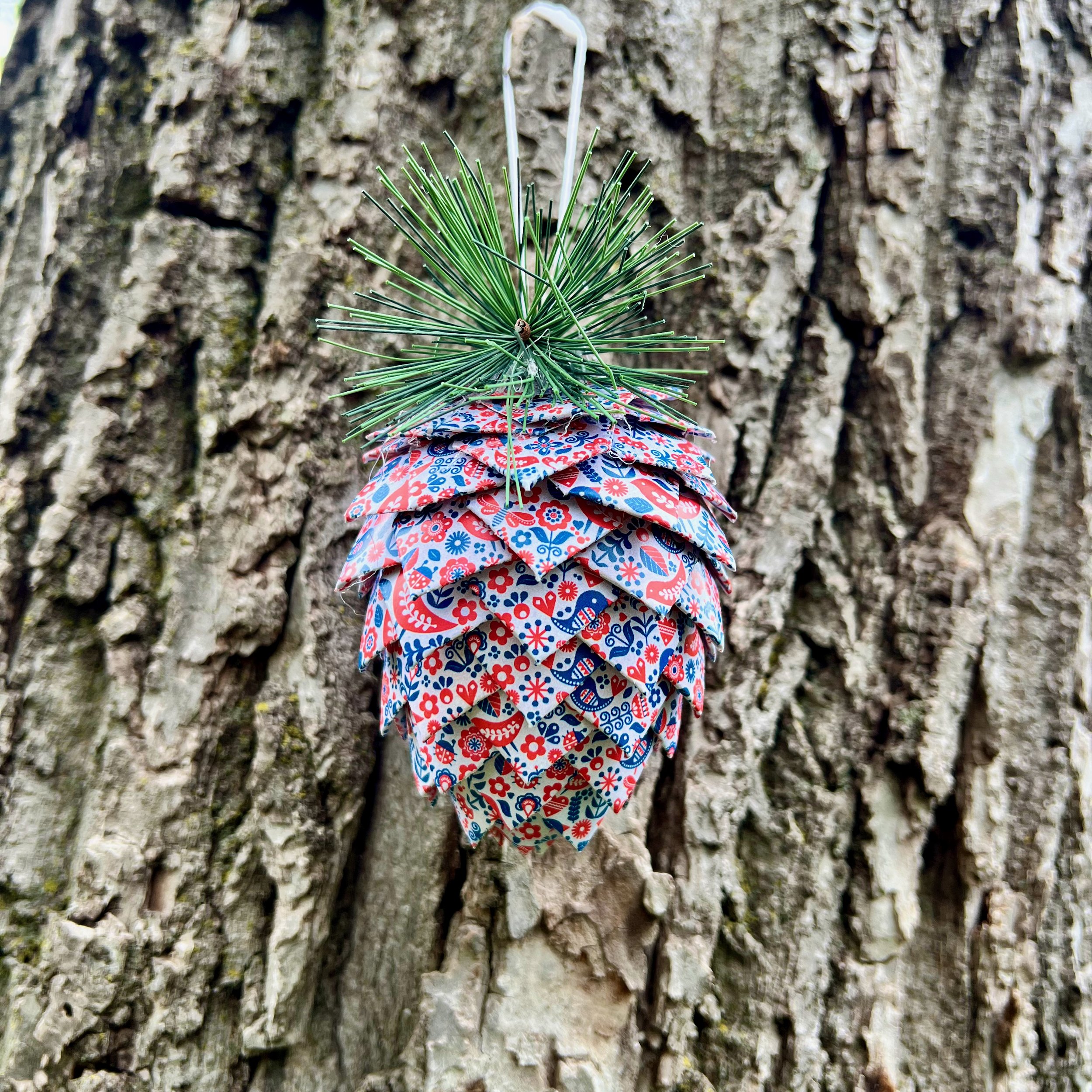 bird flowers red blue pinecone bark background.jpeg