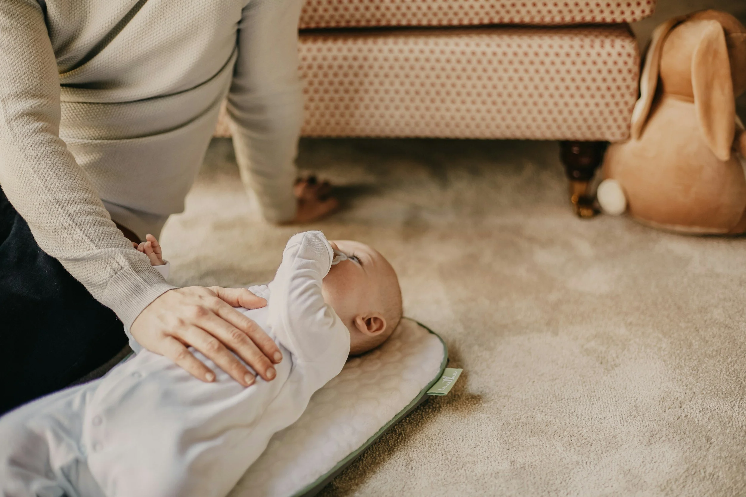 baby lying on the floor with pacifier