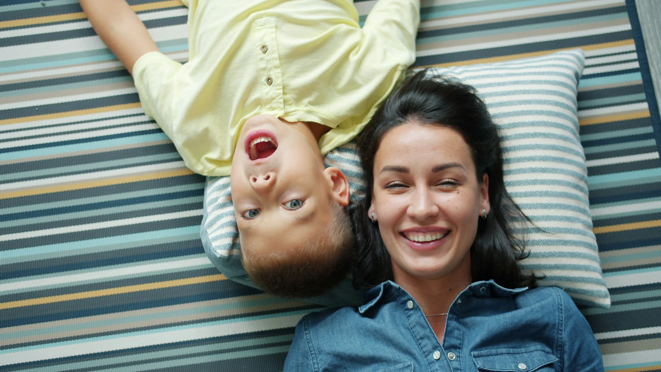 mother and toddler child laying down having fun