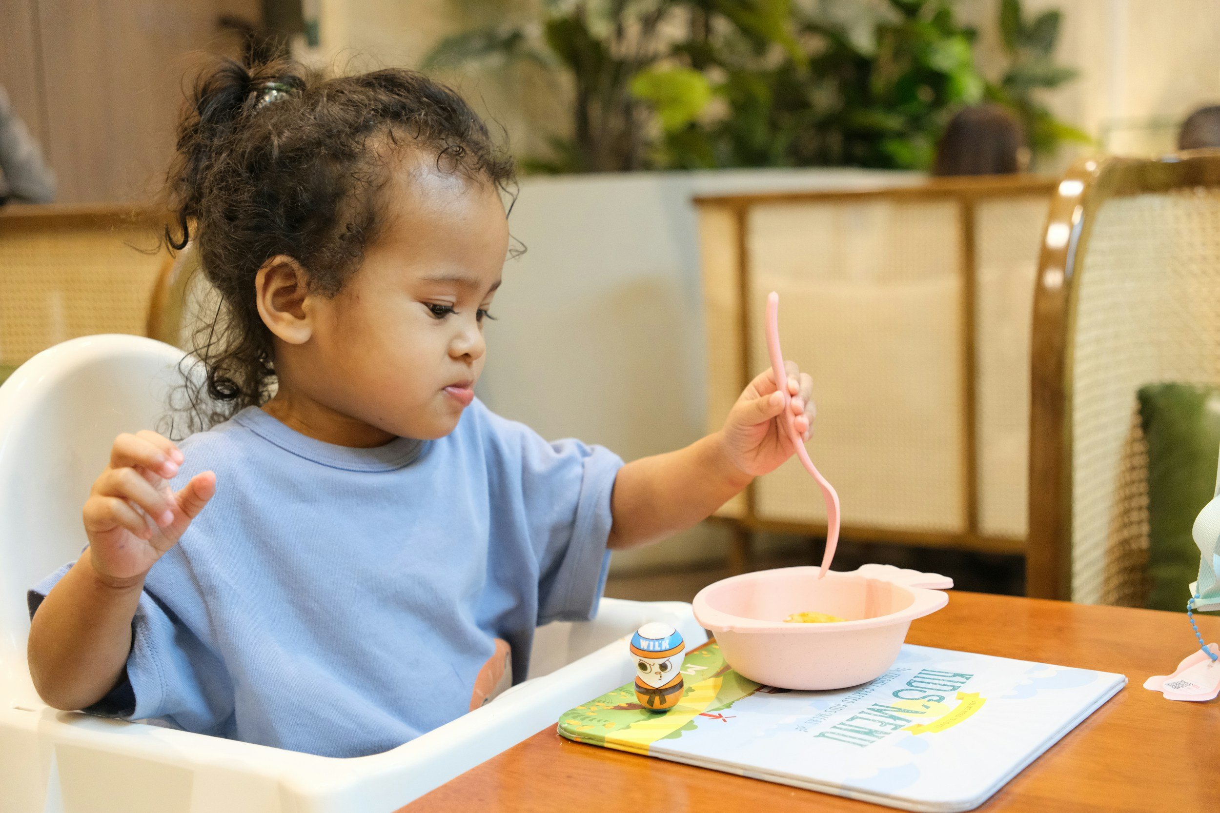 toddler eating in high chair, picky eater