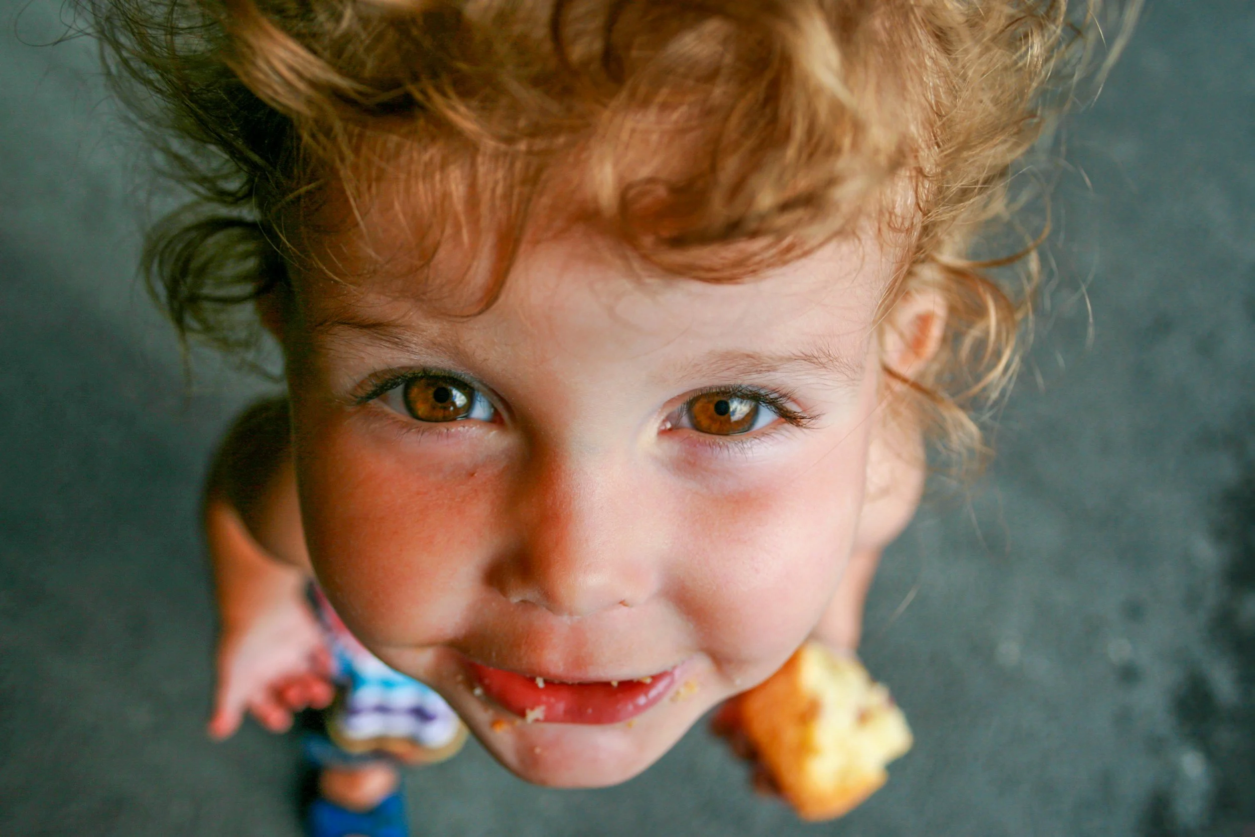 child looking up with food