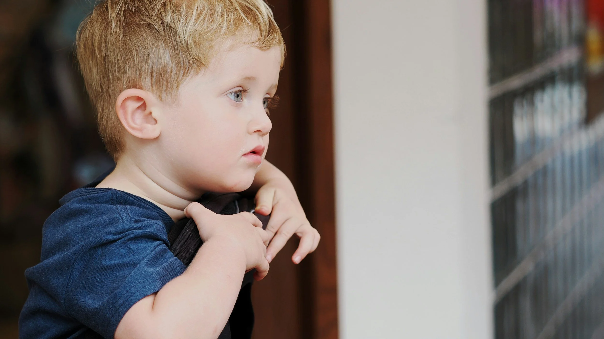 child looking out, staring outside
