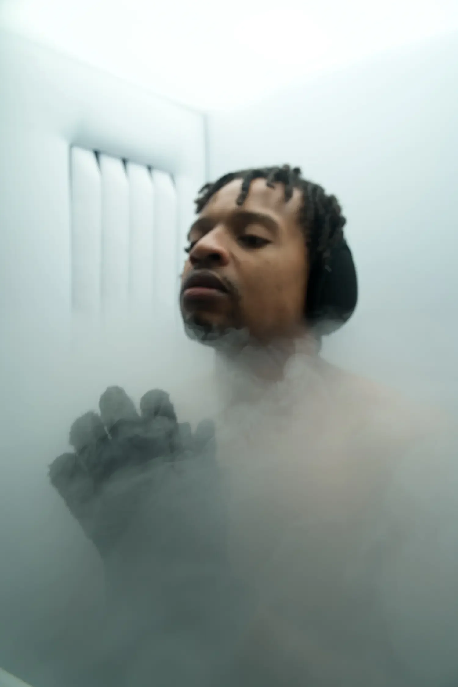 Client inside the cryotherapy chamber surrounded by cold vapor during a session
