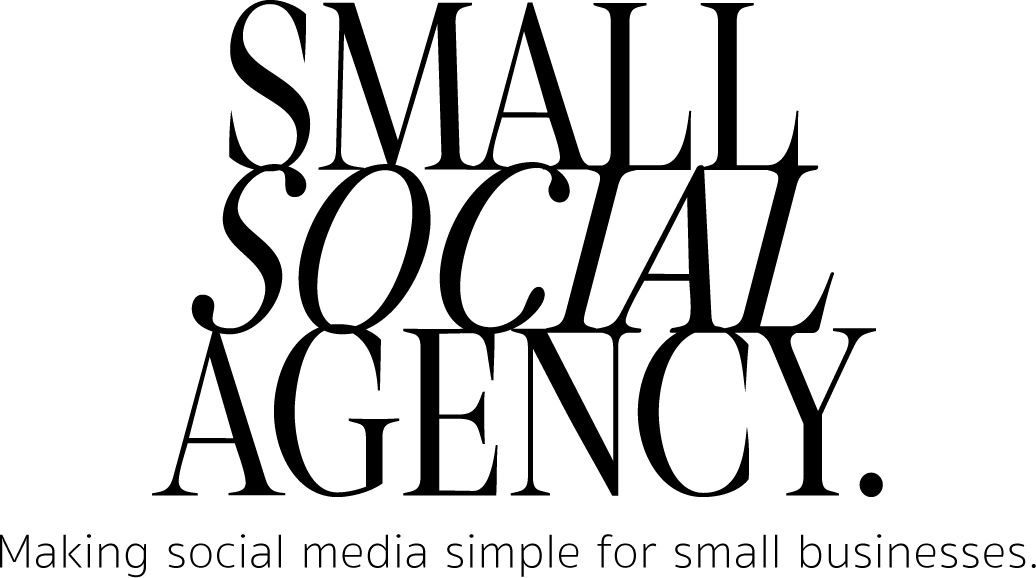 Black-and-white image of a young woman with dark hair, sitting at a desk with her hand on her chin, looking at a computer screen.