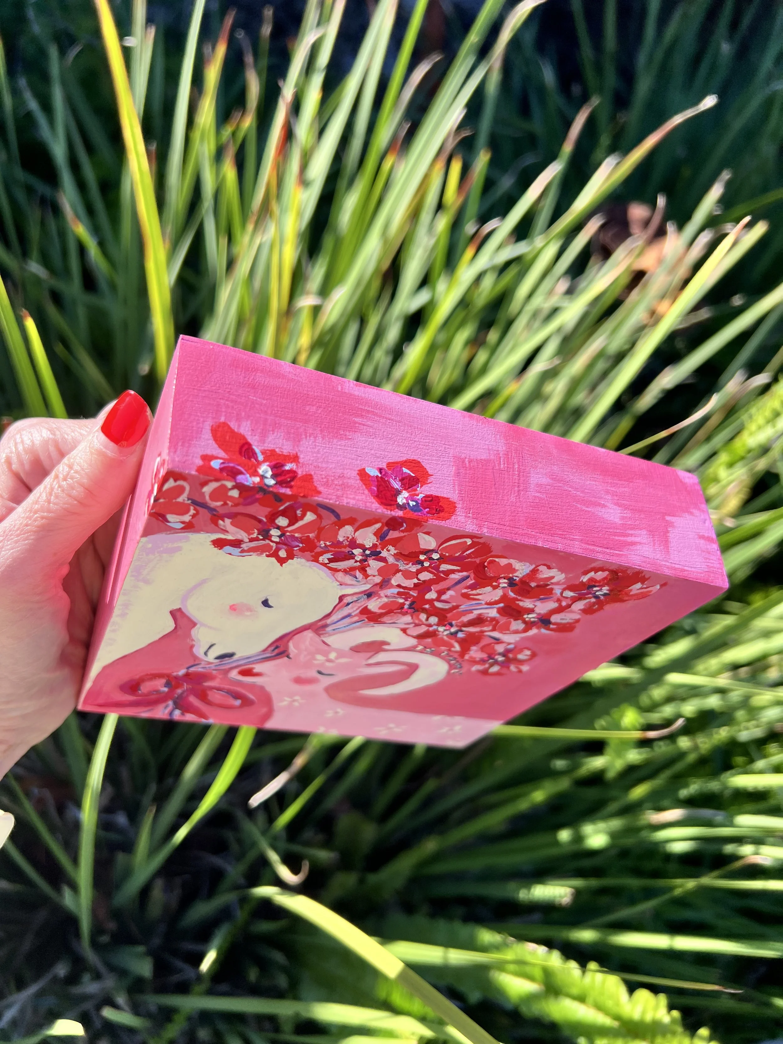 Je t'aime Original artwork. A white horse and pink goat in tender embrace, crowned with red blossoms. Created for the Lunar New Year to celebrate love's ability to transcend all boundaries.