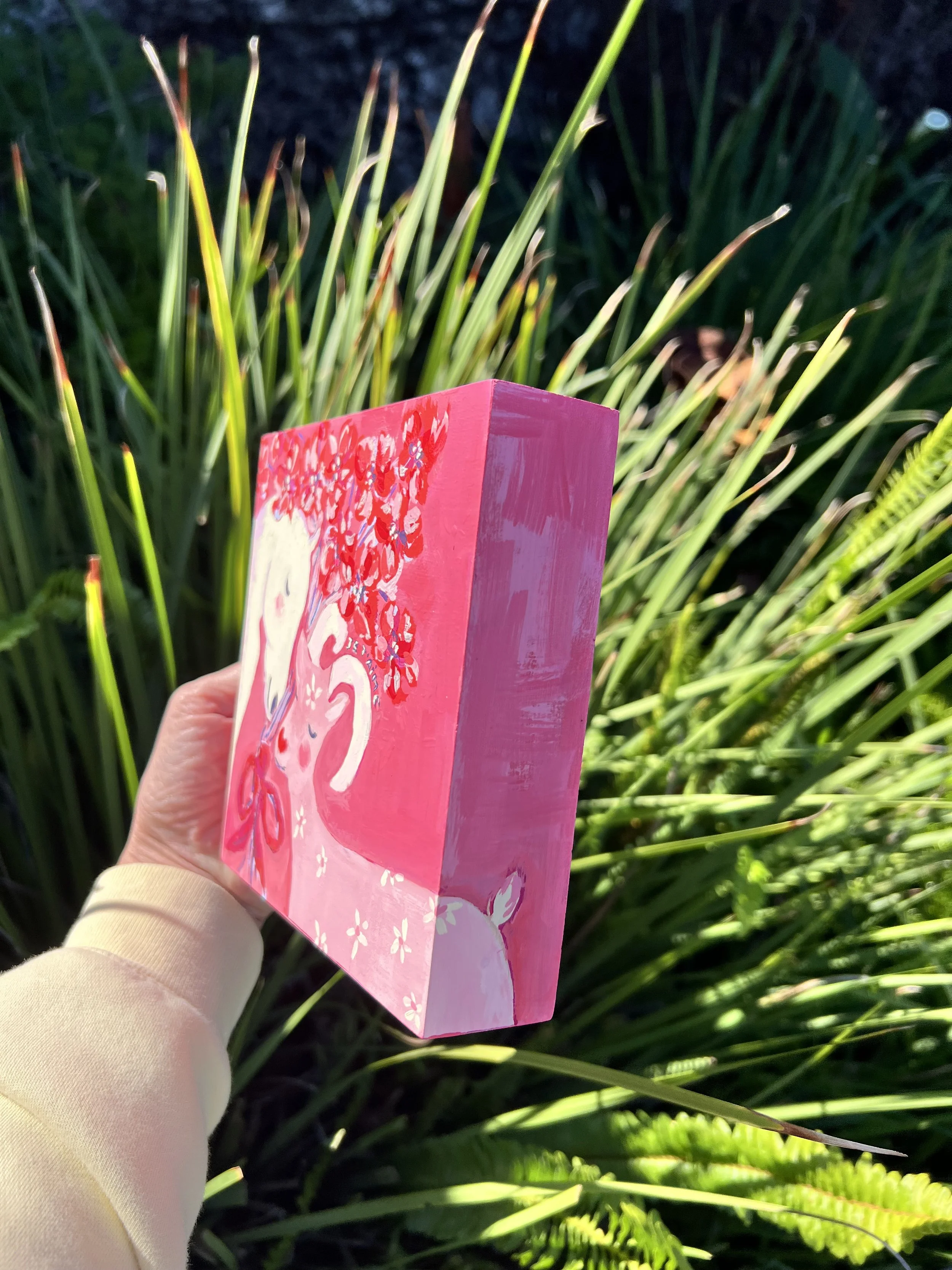 Je t'aime Original artwork. A white horse and pink goat in tender embrace, crowned with red blossoms. Created for the Lunar New Year to celebrate love's ability to transcend all boundaries.