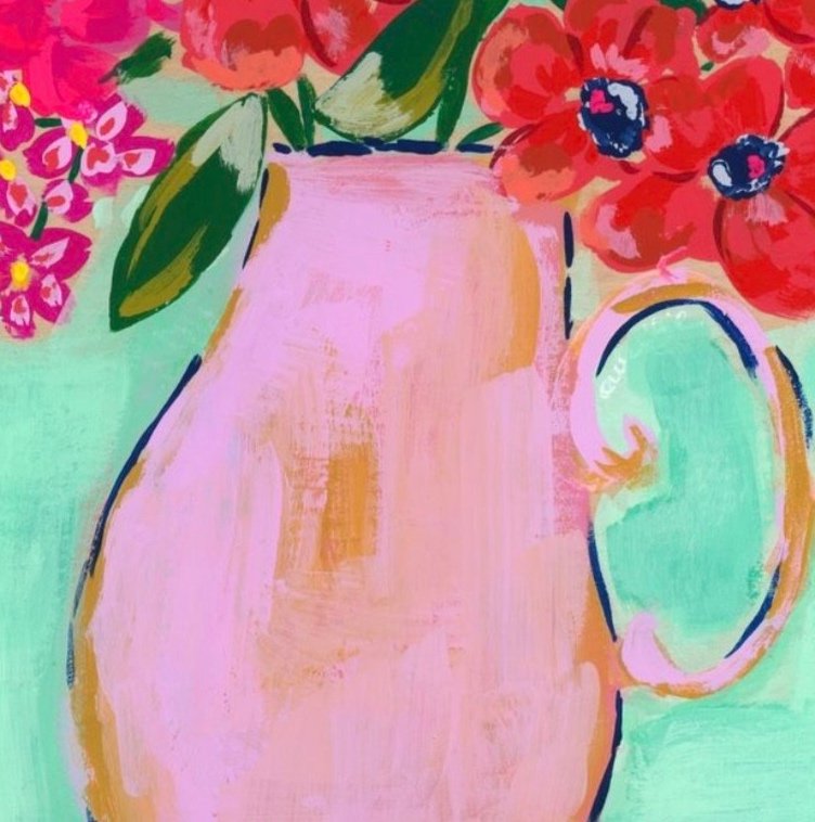 A stunning arrangement featuring bright red blooms and delicate hot pink florals. Round pink vase with handle. Monochromatic bouquet against soft mint background.