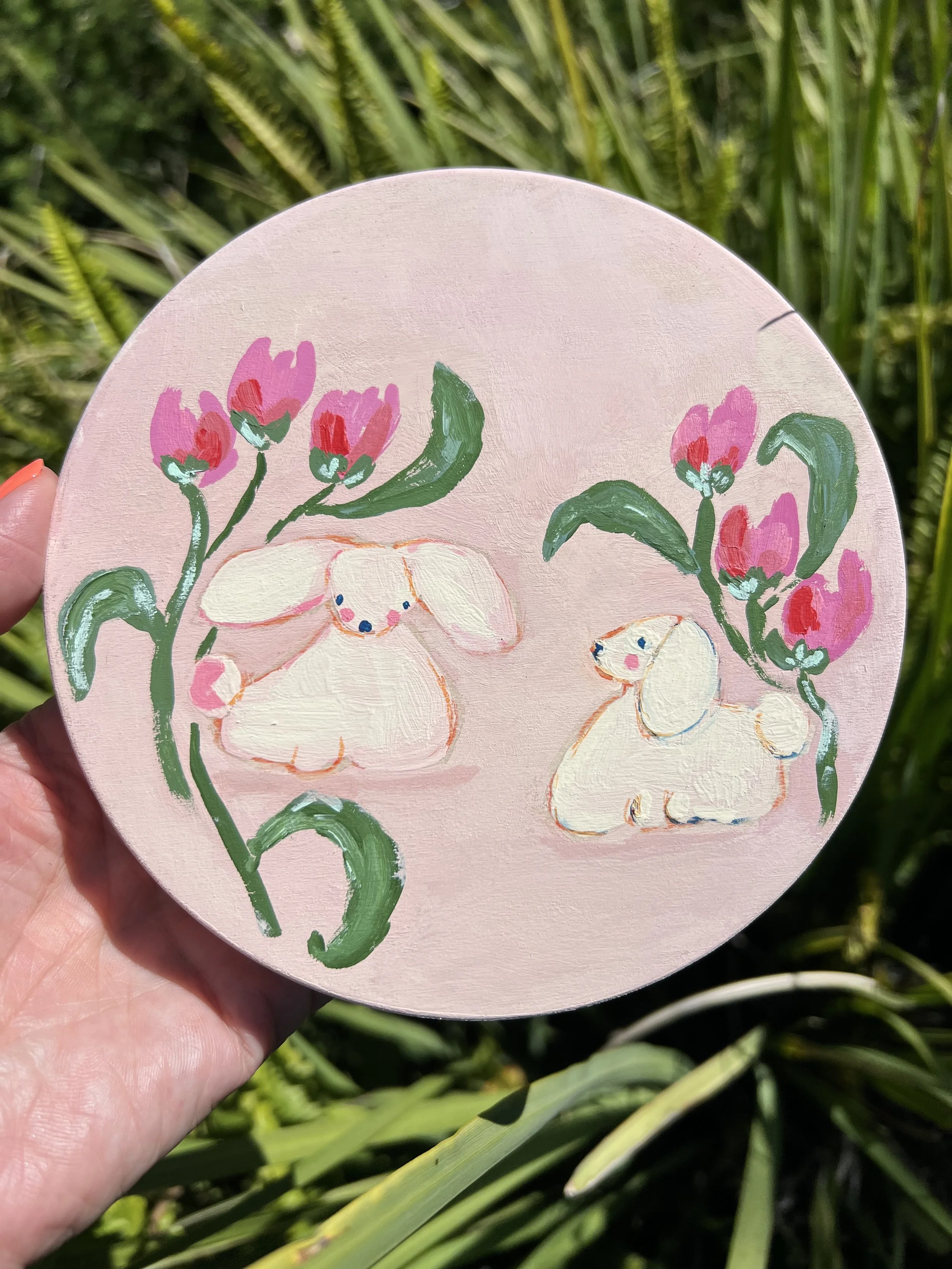 Playful little poodles with loose, fluffy bodies, tiny faces, & floppy ears on a whimsical pink background.