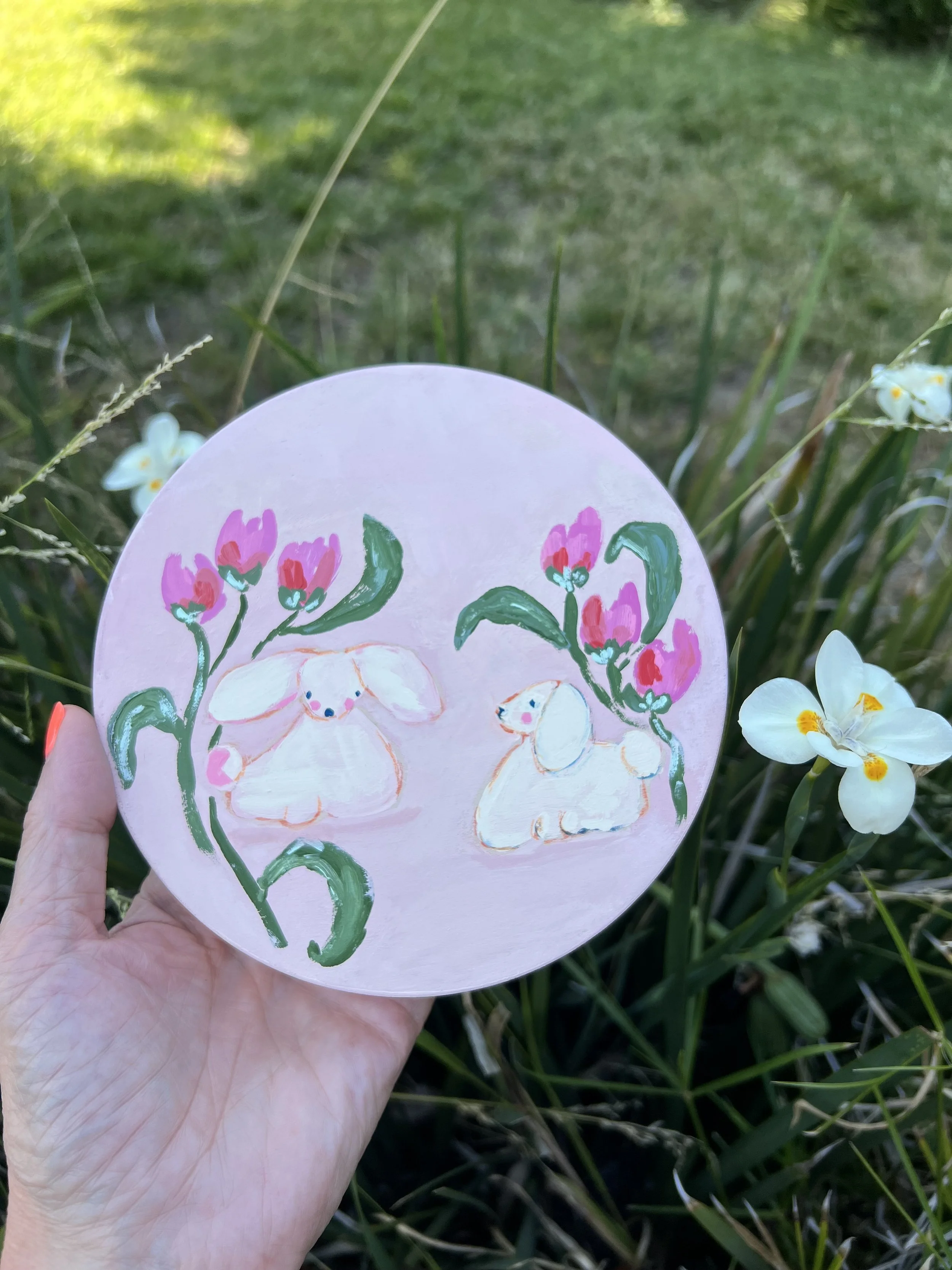 Playful little poodles with loose, fluffy bodies, tiny faces, & floppy ears on a whimsical pink background.