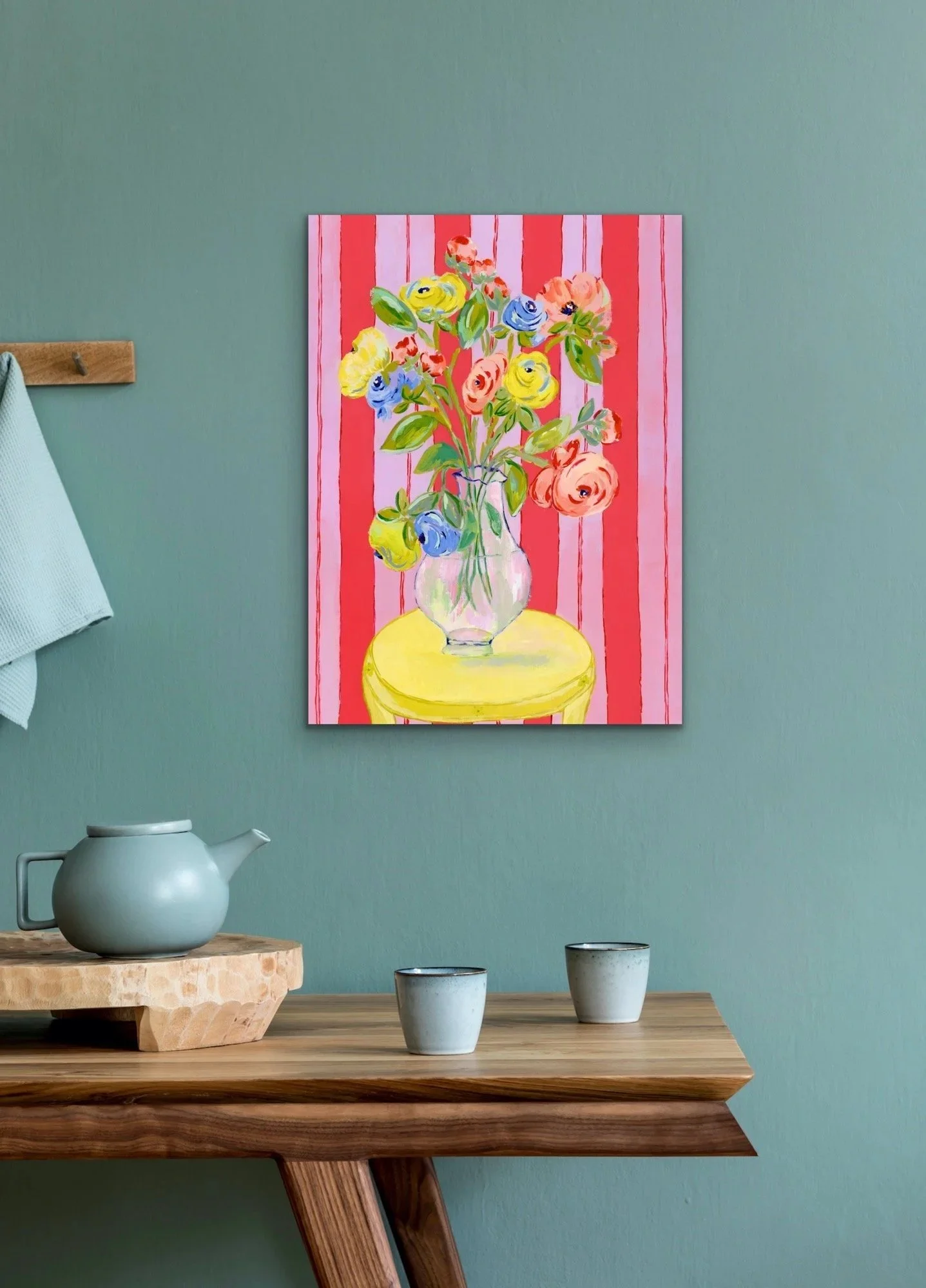 Grand Arrangement of a large bouquet of ranunculus in a transparent vase on bright yellow table. Red and lavender background.