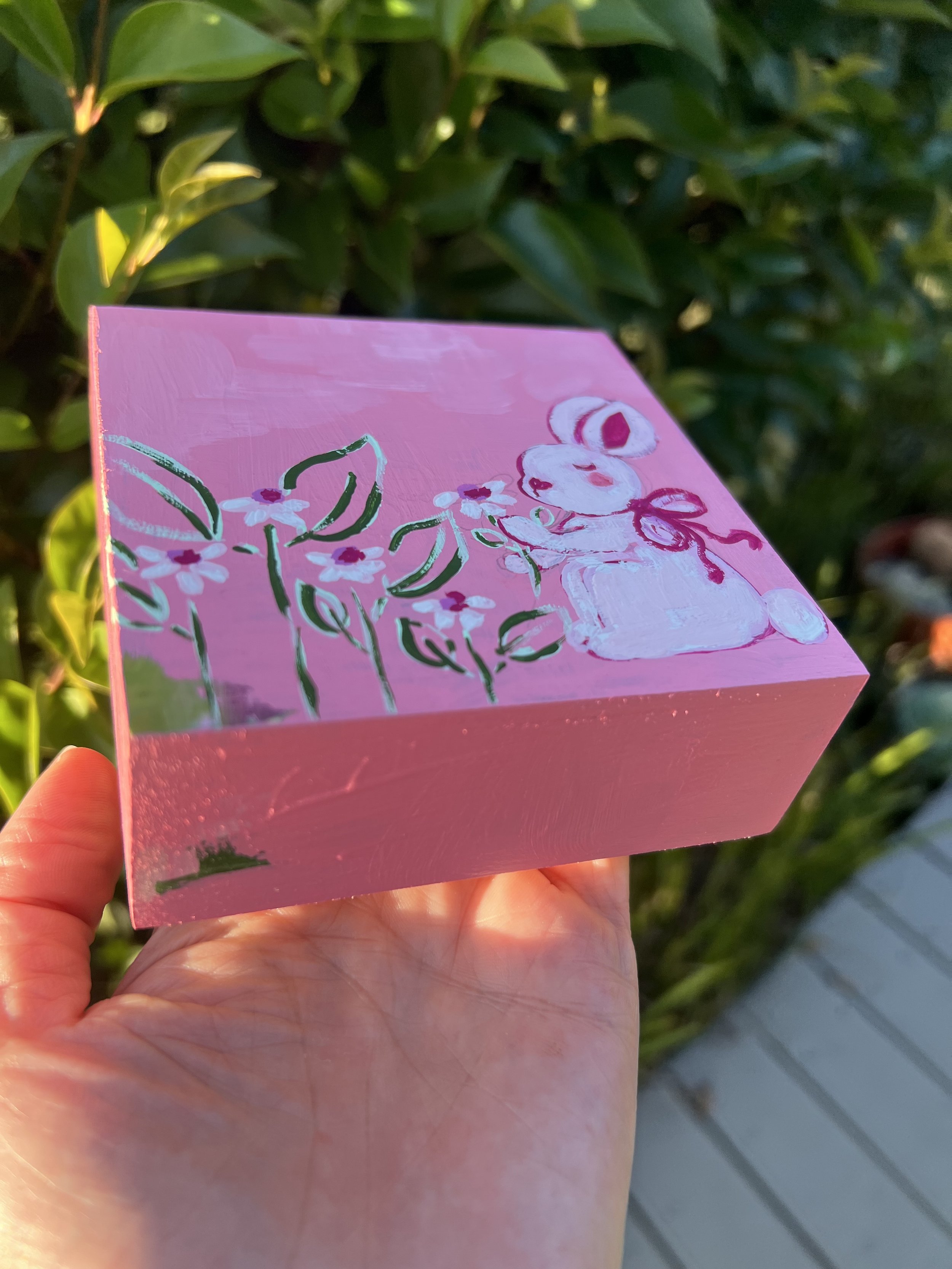 Charming piece featuring a bunny surrounded by flowers, painted over an abstract background. Perfect for nurseries, children's rooms, or anyone who loves whimsical art with character.