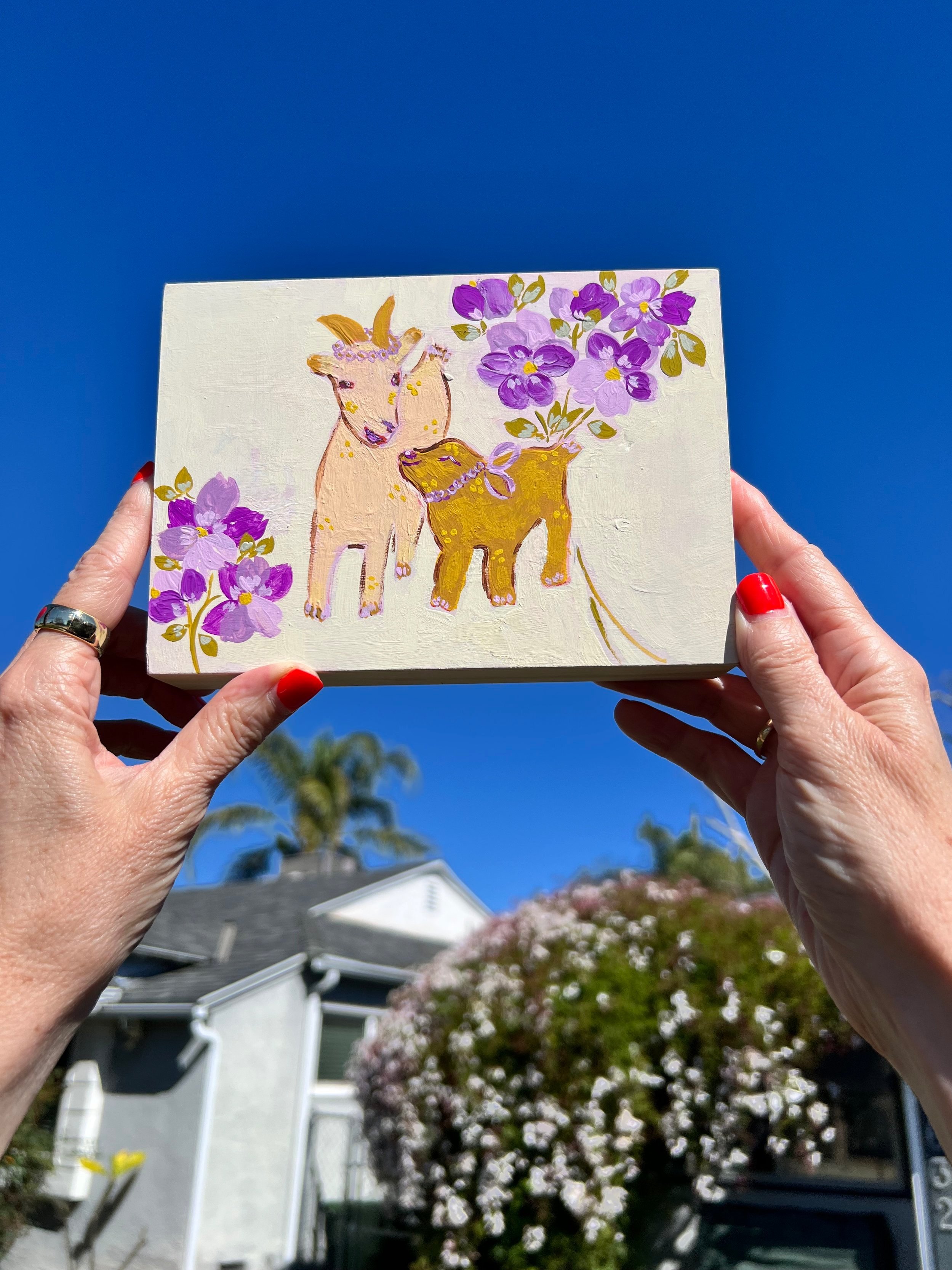 Charming painting of Mama Goat and her little one. Love and care. Loose purple flowers. Perfect for nurseries, children's rooms, or for a touch of whimsy and color.