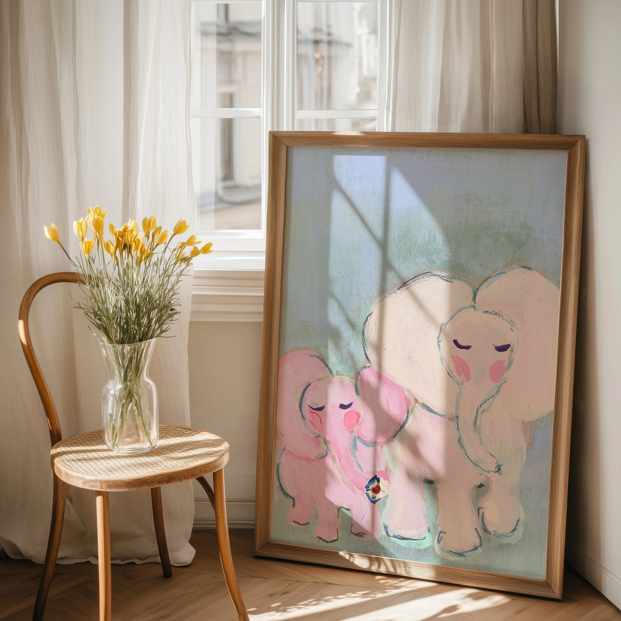 Fine Art Print in large frame on floor. Together Always, is a tender elephant duo painted in the softest pinks and mints to bring peace and serenity with this petite artwork.