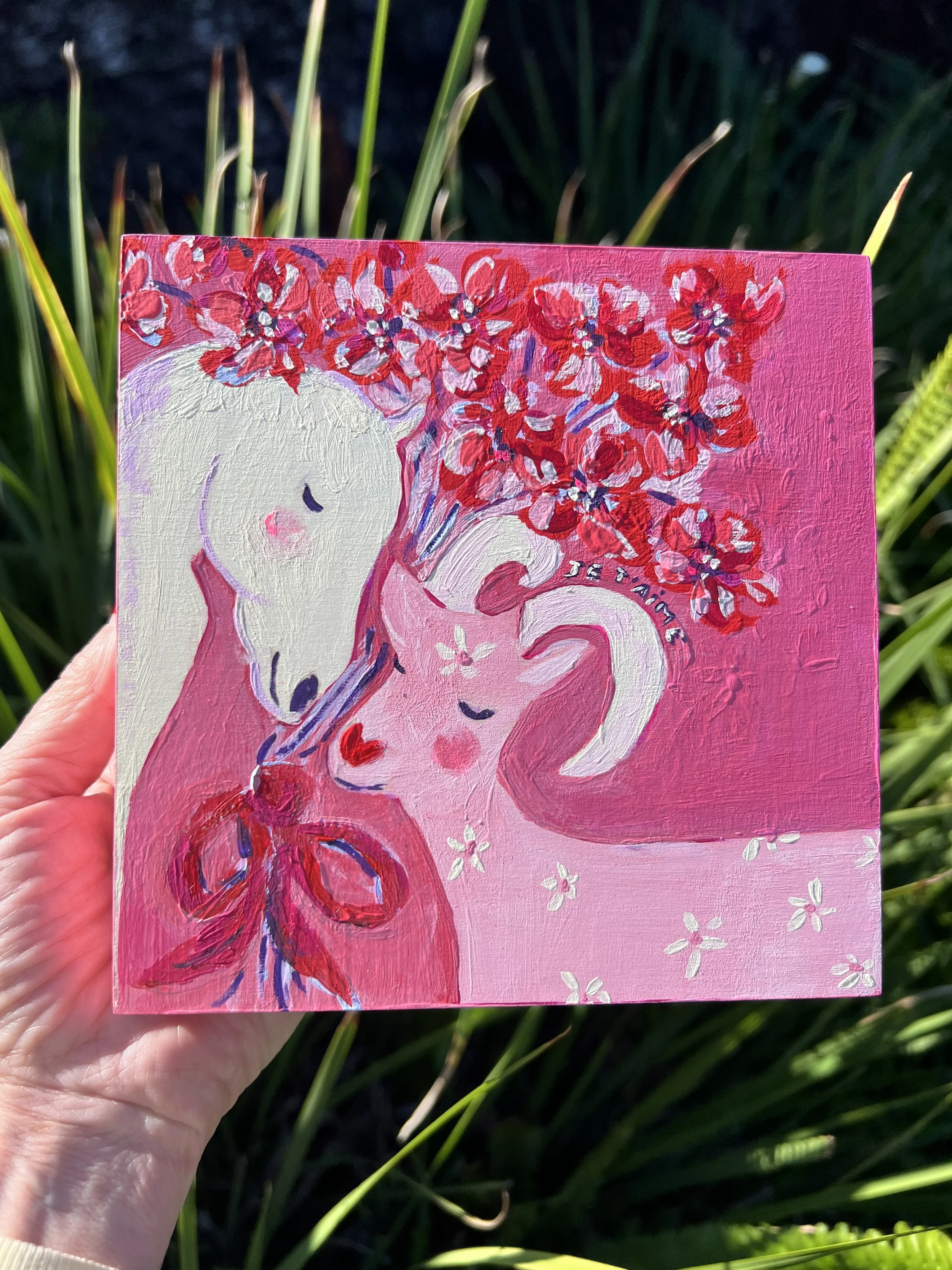 Je t'aime Original artwork. A white horse and pink goat in tender embrace, crowned with red blossoms. Created for the Lunar New Year to celebrate love's ability to transcend all boundaries.