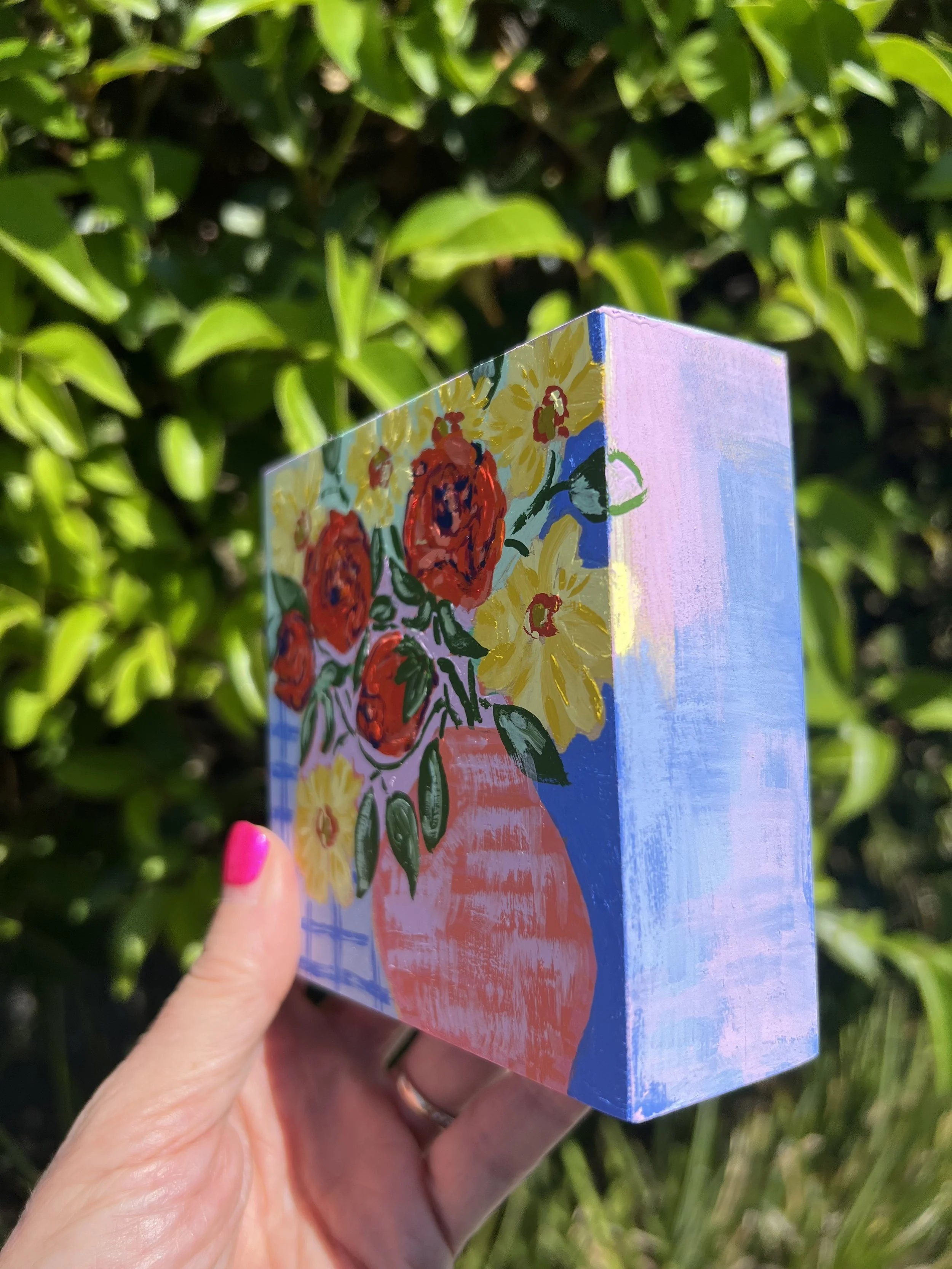 Original gouache painting of my weekly bouquet featuring bold orange roses and bright yellow ranunculus on an abstract and colorful background.