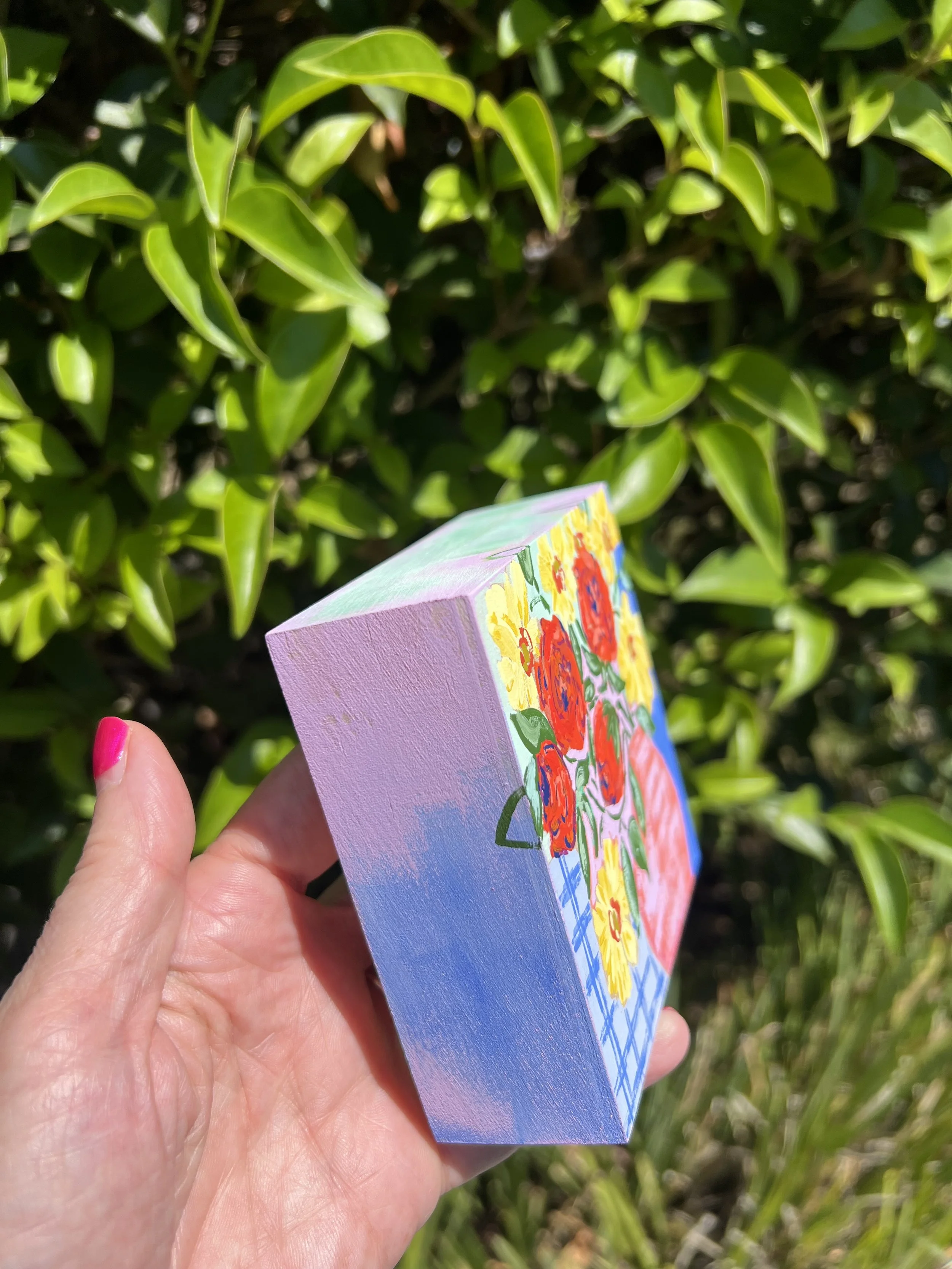 Original gouache painting of my weekly bouquet featuring bold orange roses and bright yellow ranunculus on an abstract and colorful background.