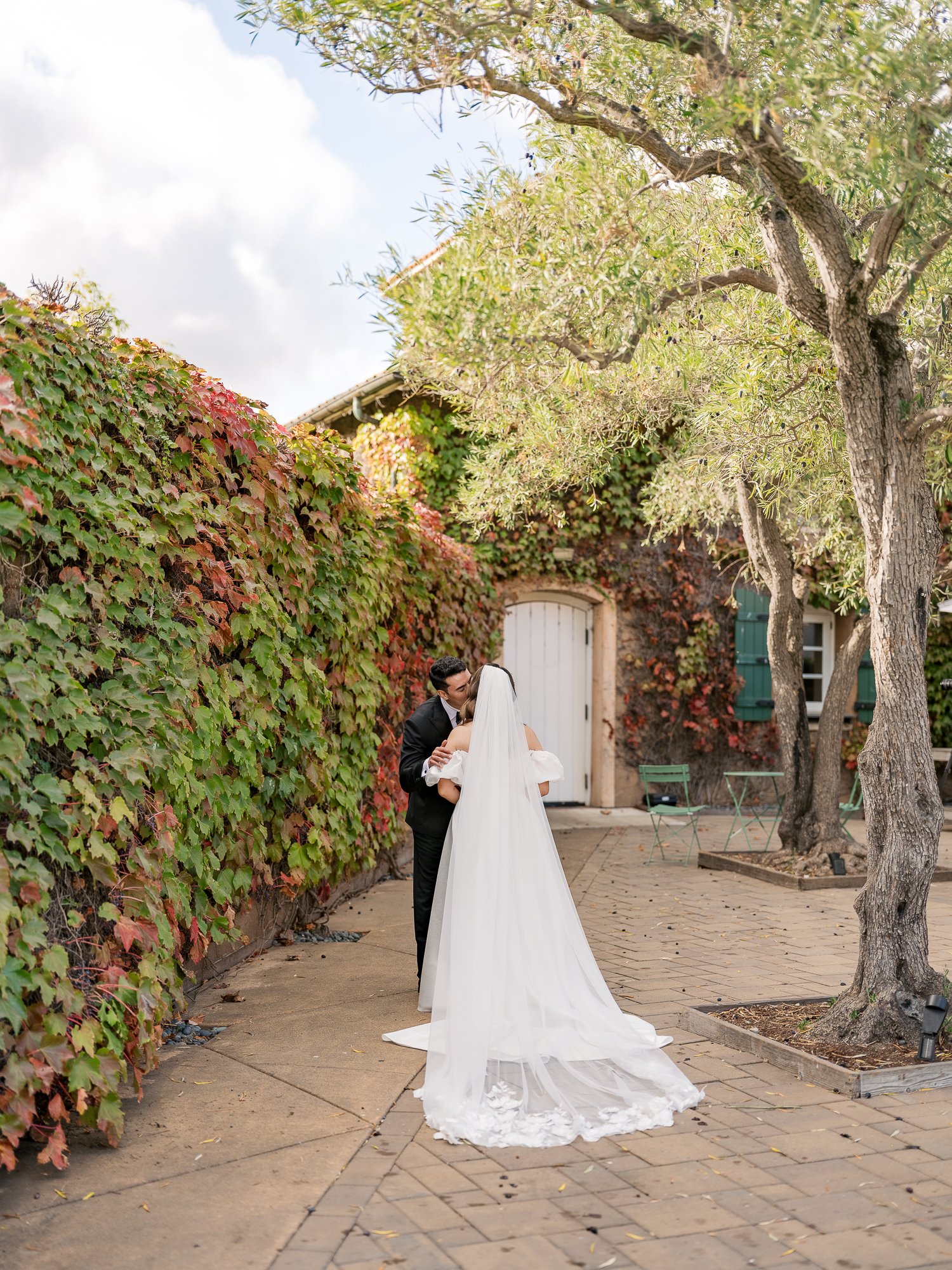 bride and groom share a kiss during their autumn wedding in napa valley