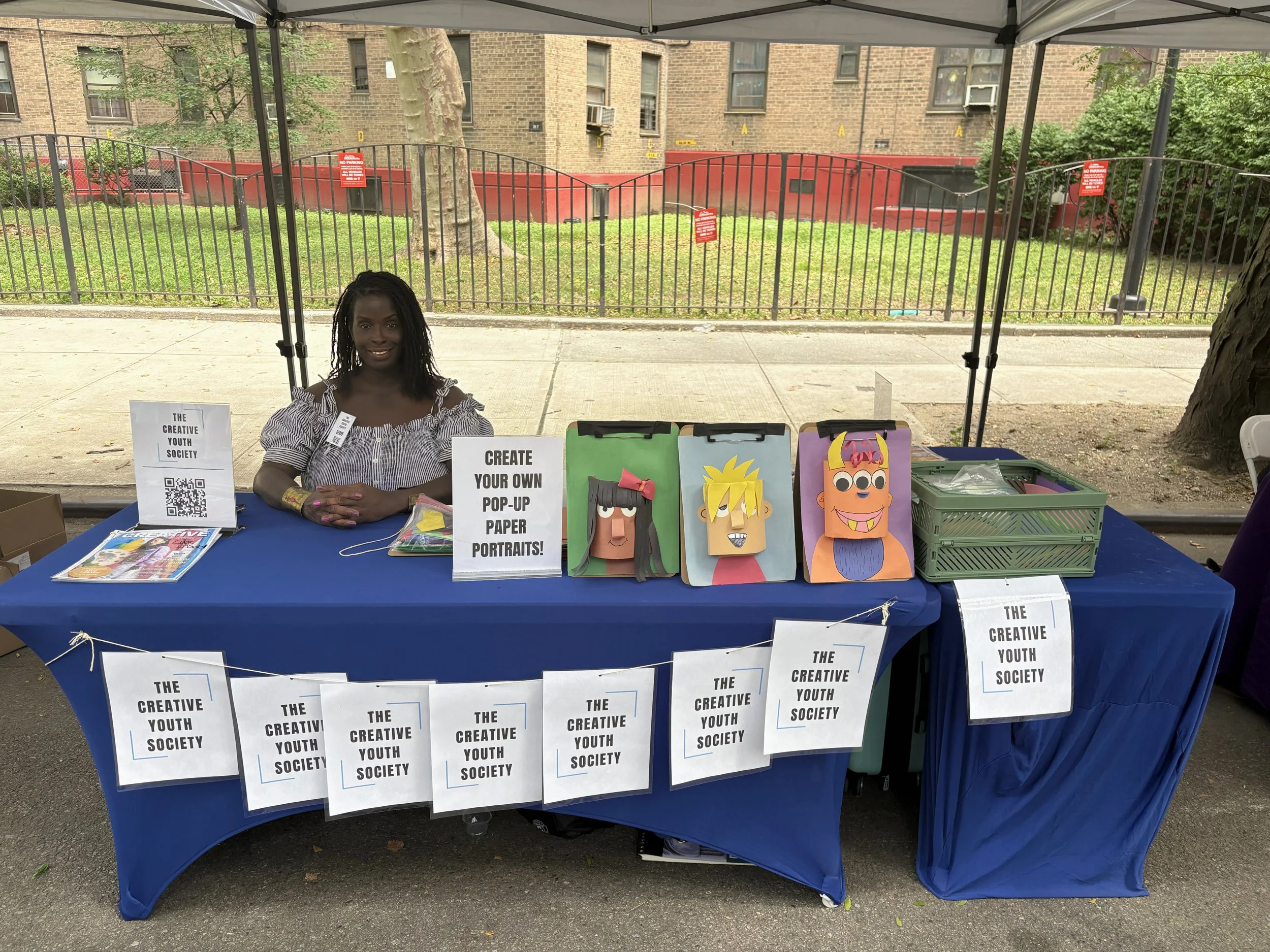 The founder of CYS seated at our art station table in partnership with NYC DOT Summer Streets