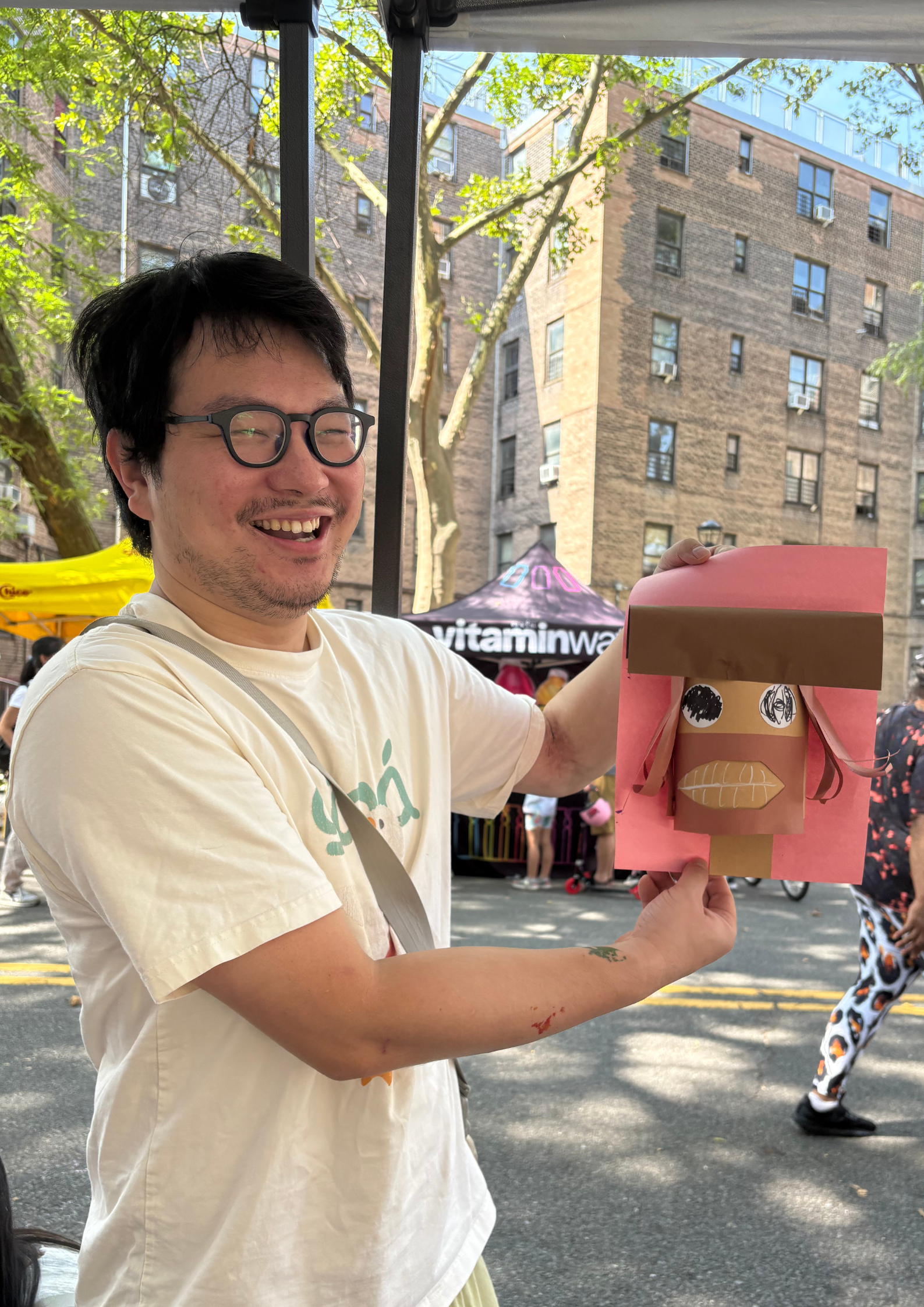 A participant proudly showing off their artwork at our CYS x NYC DOT Summer Streets art station.