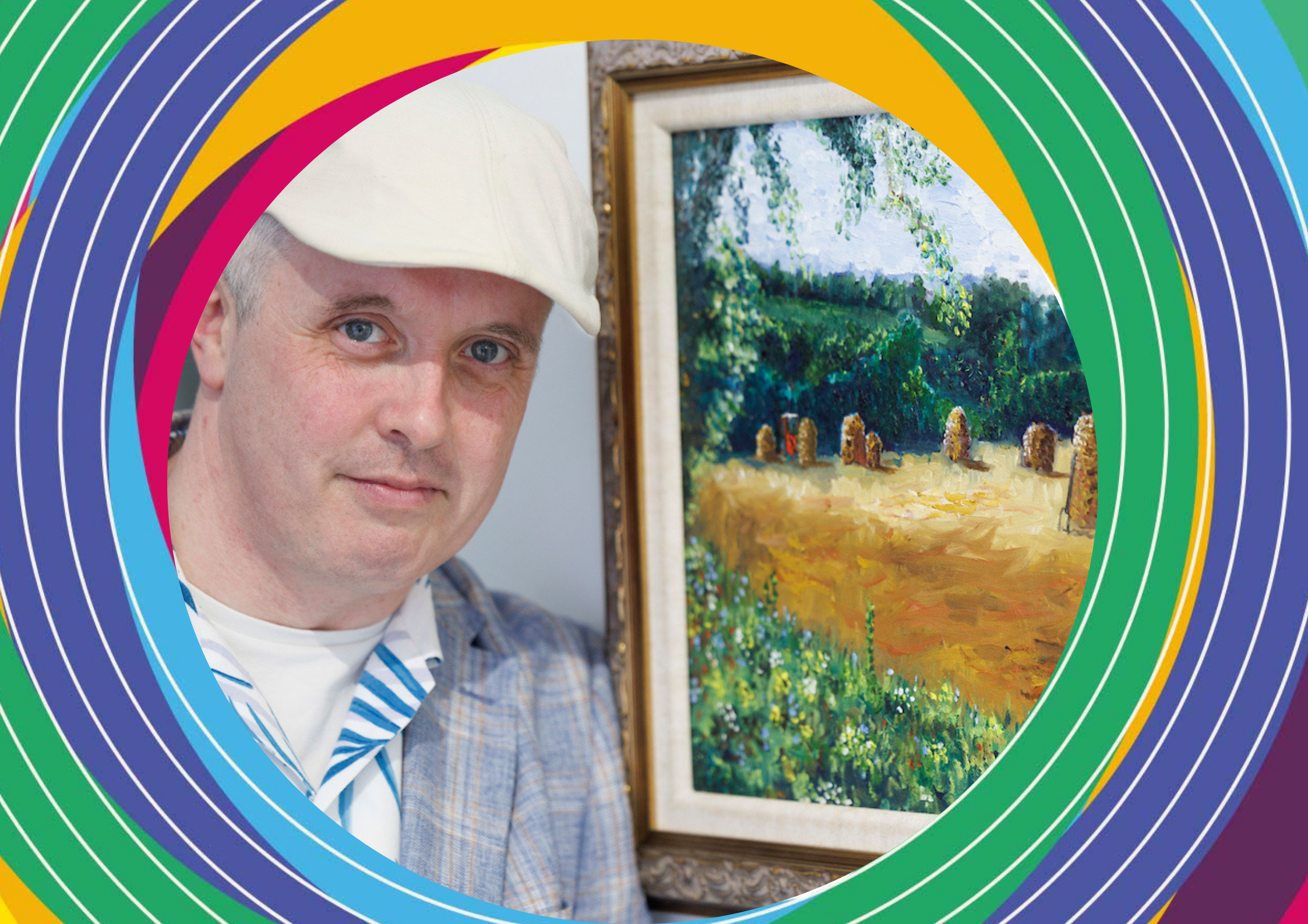 Artist Thomas Higgins, a man wearing a grey suit jacket and a white Irish flat cap poses next to his artwork of haybales.