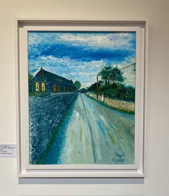 Impressionistic oil painting of a stone building with arched windows and a steep roof, flanking a wet road on a cloudy day.