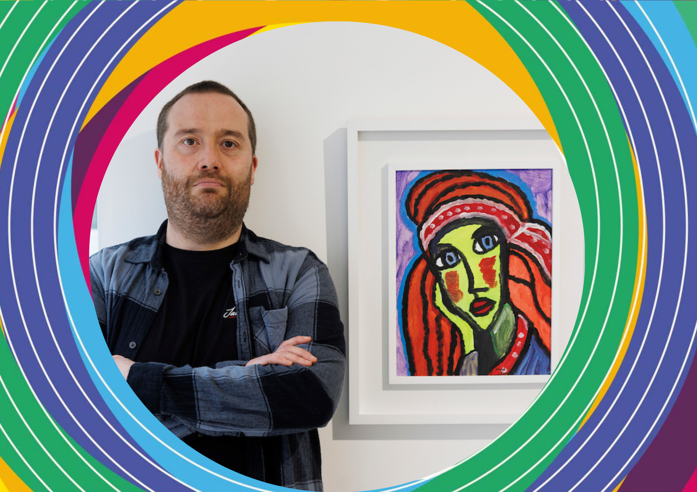 Man with arms crossed standing next to a framed colorful painting of a female face. Image framed with a vibrant, semi-circular design of alternating stripes in yellow, pink, green, and blue.