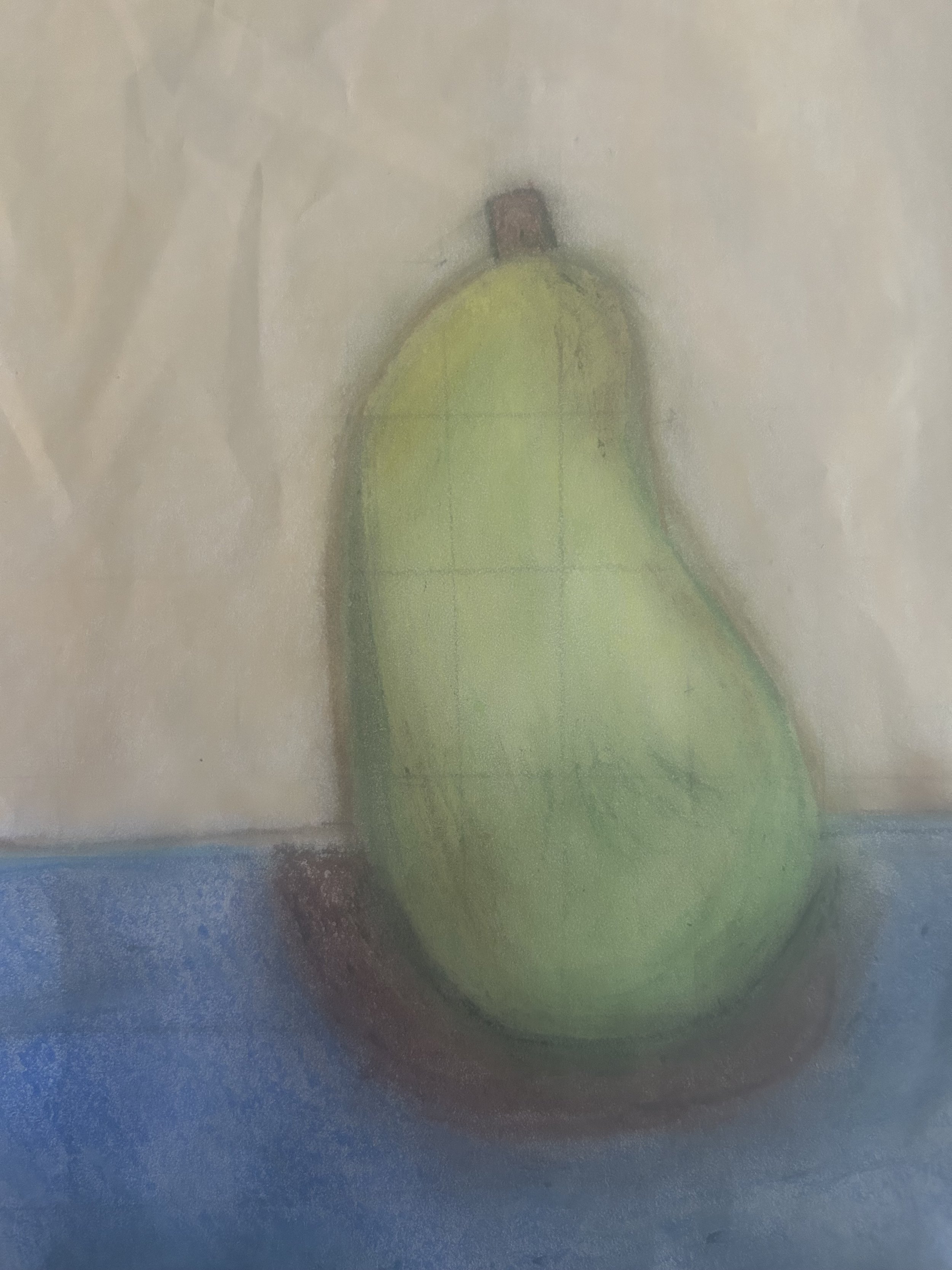 green pastel pear on a tabel with a calm beige background