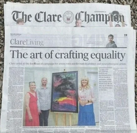 Newspaper article titled "The art of crafting equality" with a photo of three people standing next to an abstract painting.