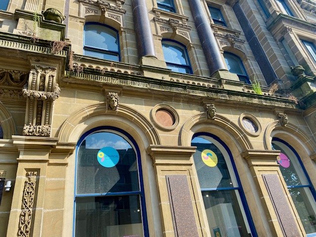 Front of the Atypical Gallery building. It is old building with lots of detail and curved windows.