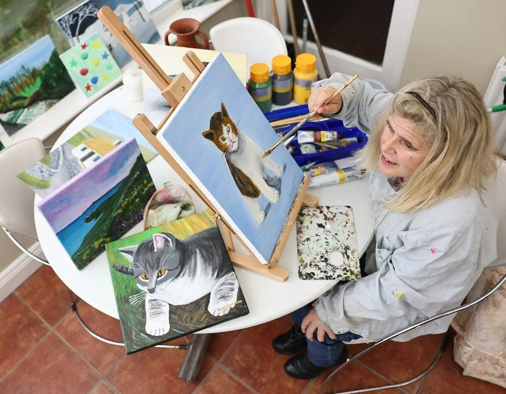 Artist Jenny Stafford paints a picture of a cat