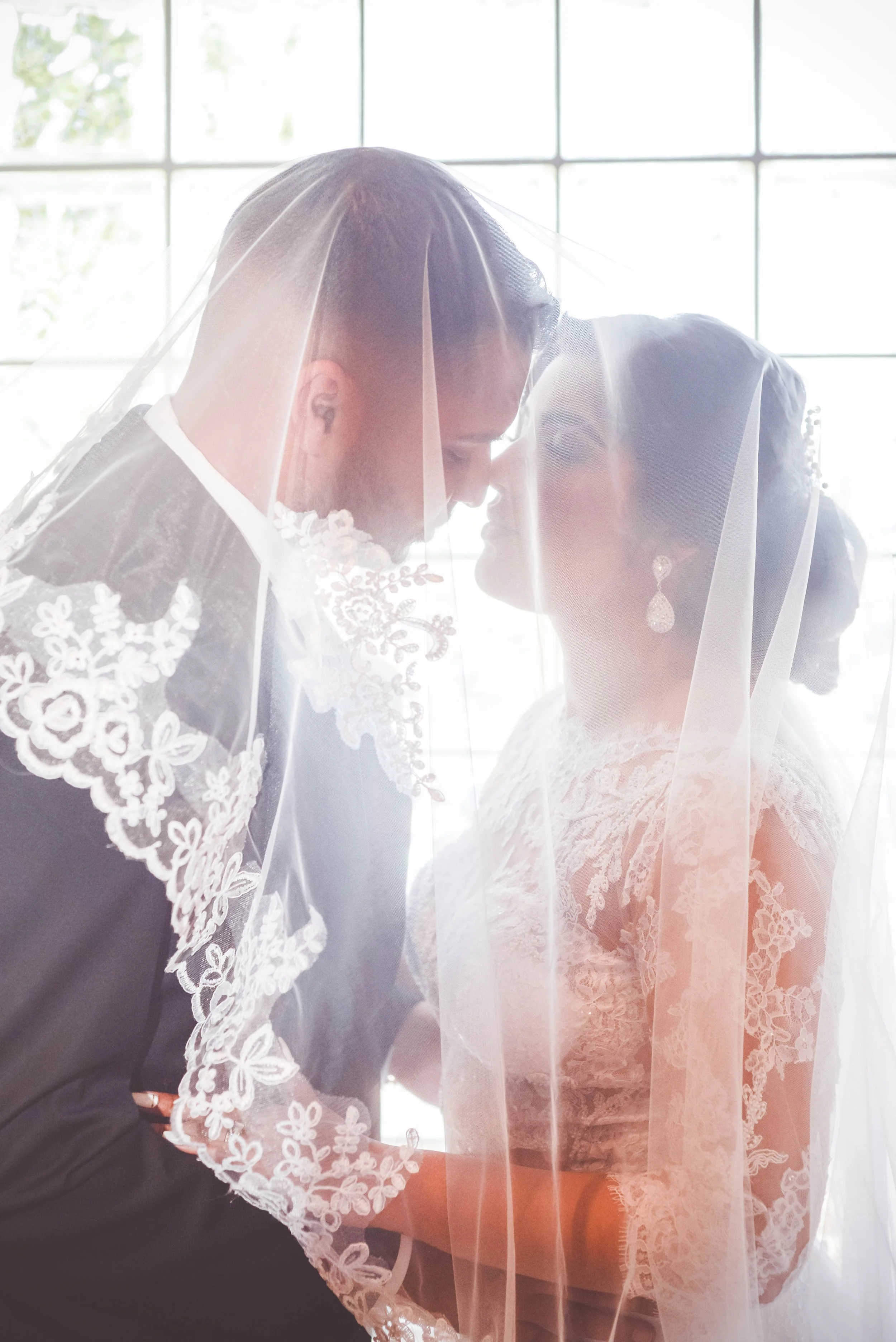 bride and groom veil portrait