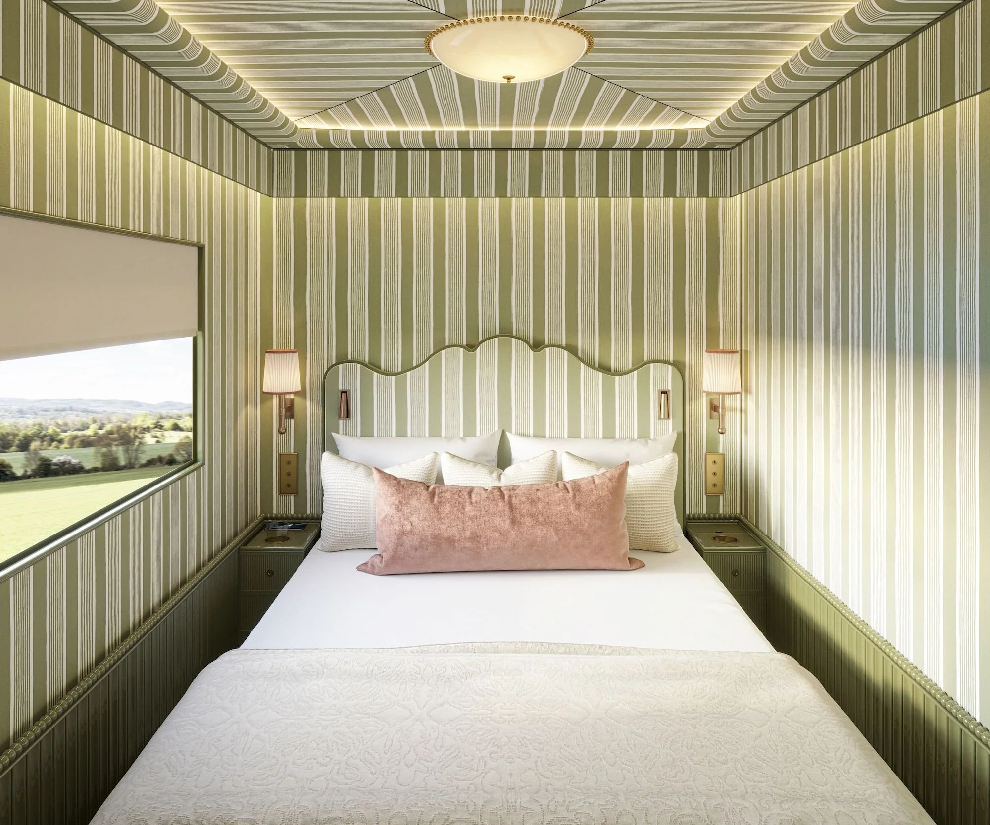 A cozy bedroom with green striped wallpaper, a large bed with white and blush pillows, and a window showing a scenic view of green fields and trees.