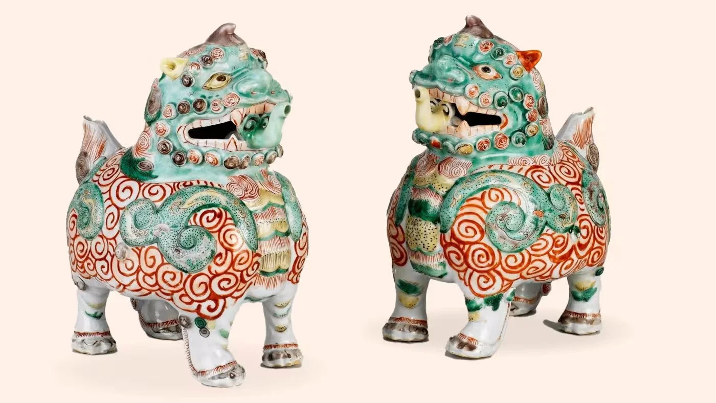 Two intricately decorated ceramic Mexican chubby dog sculptures with colorful swirl patterns, standing on four legs with open mouths, facing each other against a plain background.