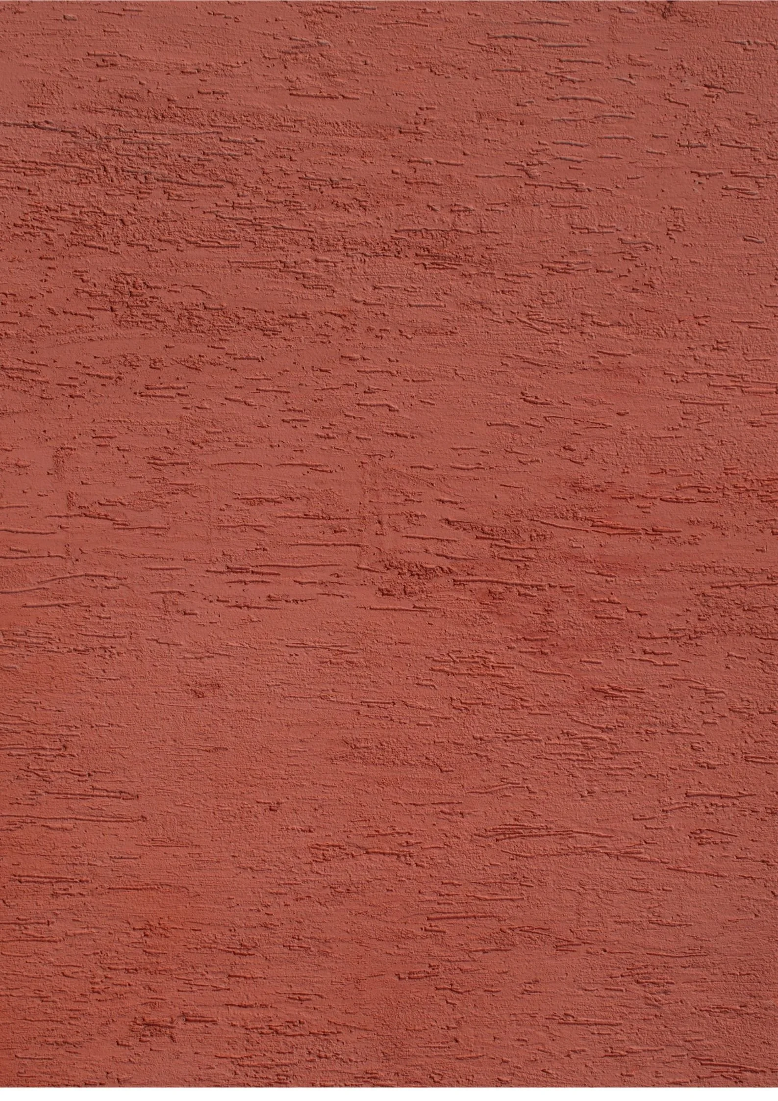 Close-up of a textured red wall with horizontal grooves and uneven surface.