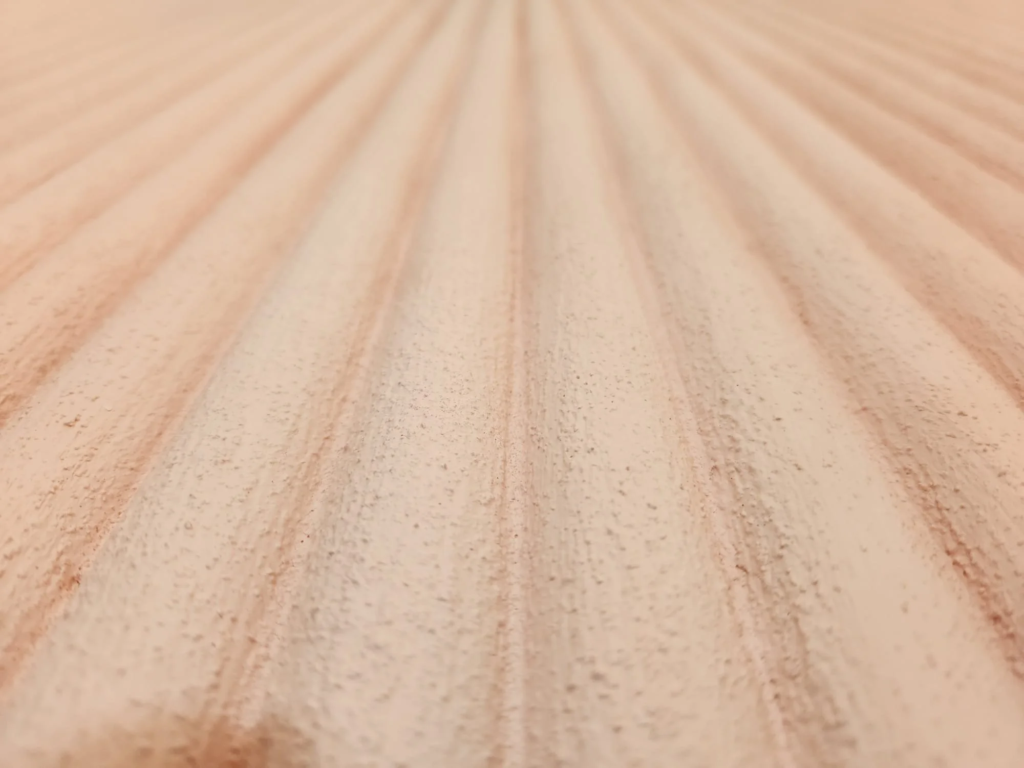 Close-up of a wooden surface with parallel grooves.