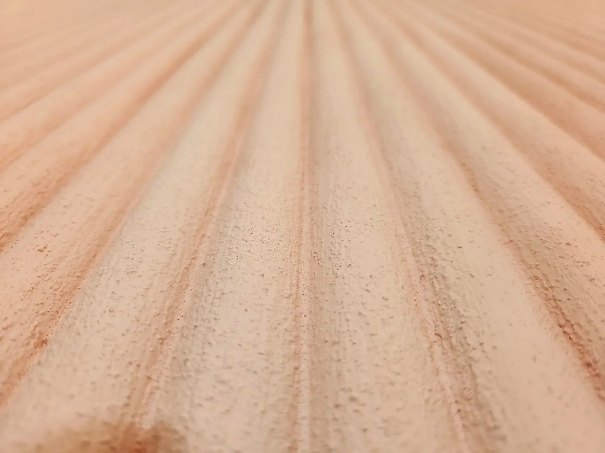 Close-up of wooden surface with parallel grooves.