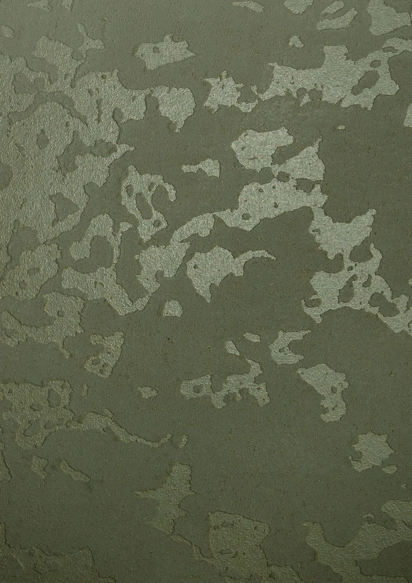 Close-up of a wall with peeling, chipped paint revealing multiple layers underneath.