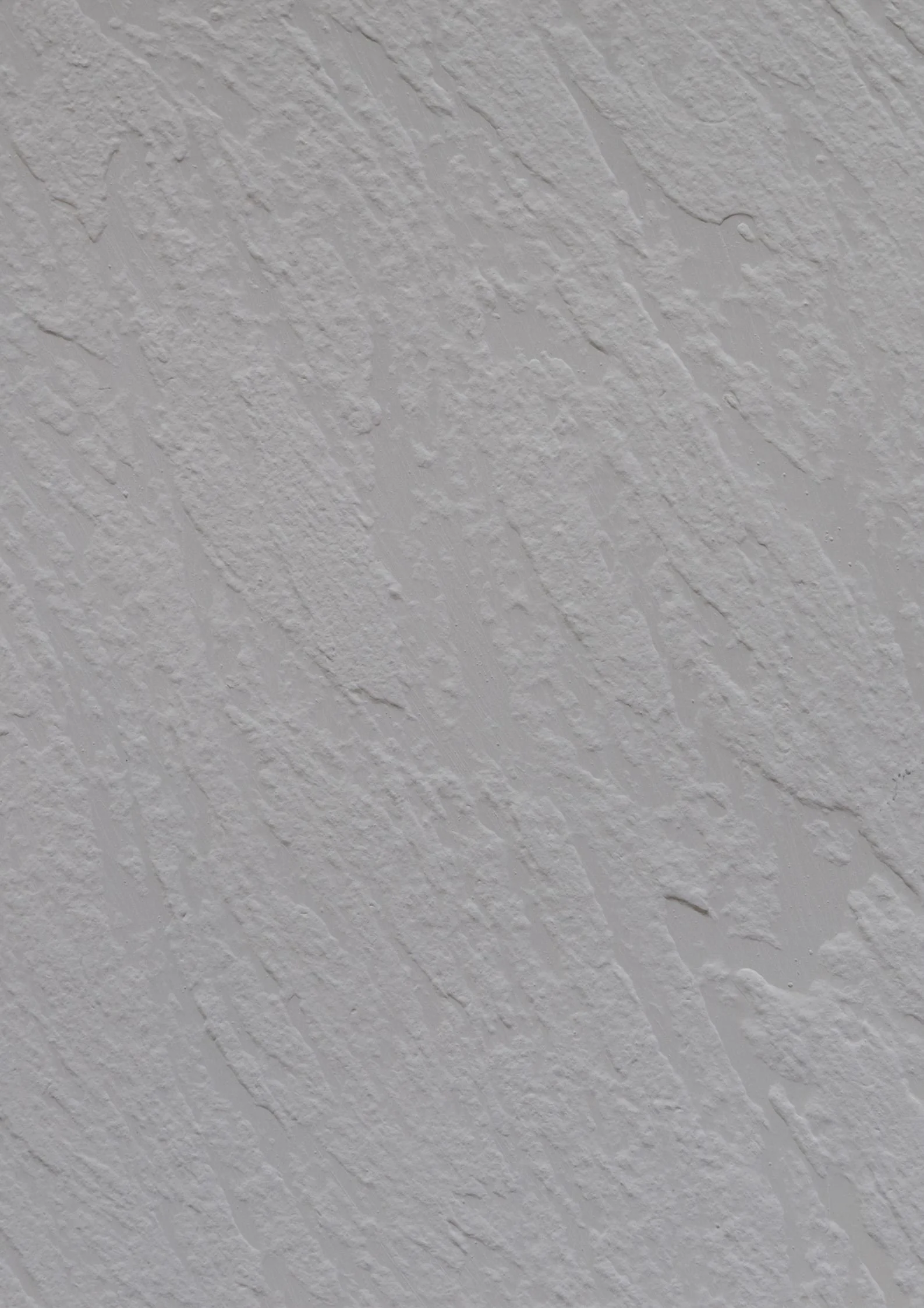 Close-up of a textured white ceiling with a stucco finish.