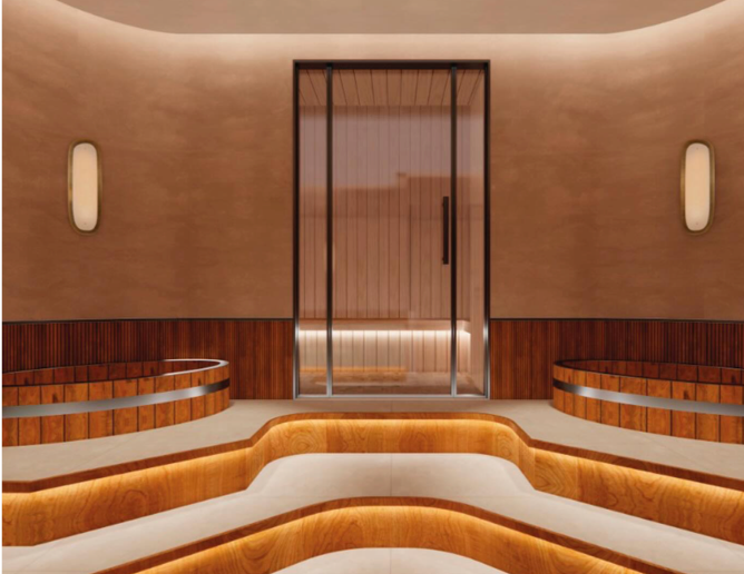 Interior of a modern, stylish spa or wellness center with a central glass door, ice bath areas, and warm lighting.