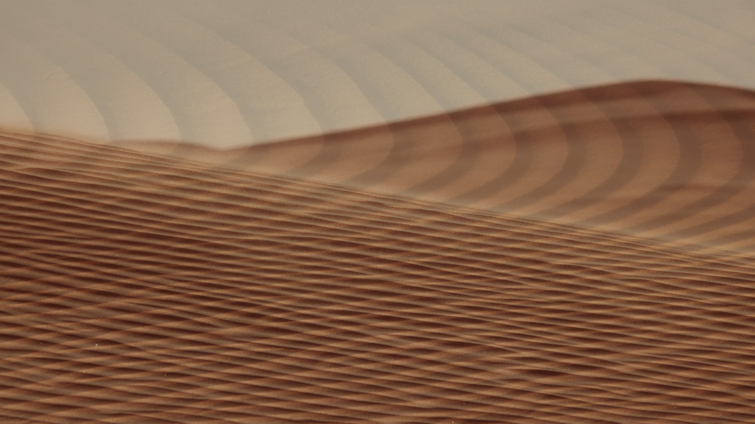 Close-up of textured paper or cardboard with wavy, corrugated pattern in brown tones.