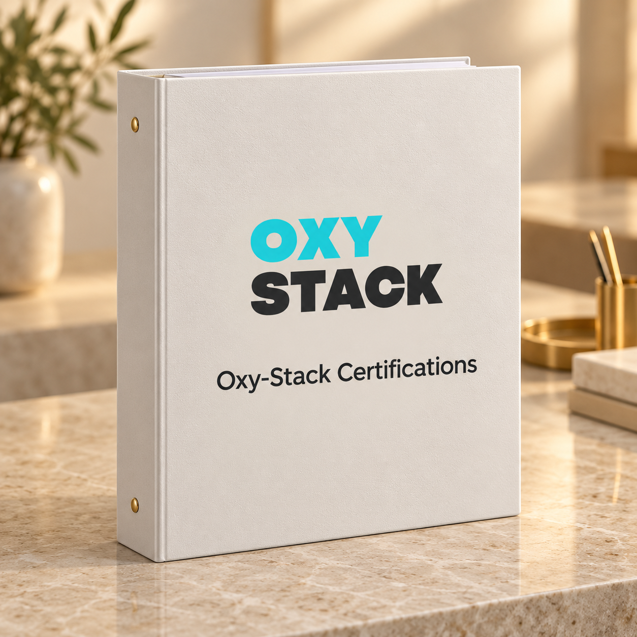 A white binder on a marble countertop with the text "OXY STACK" and "Oxy-Stack Certifications" on the cover, surrounded by a plant in the background and office supplies to the right.