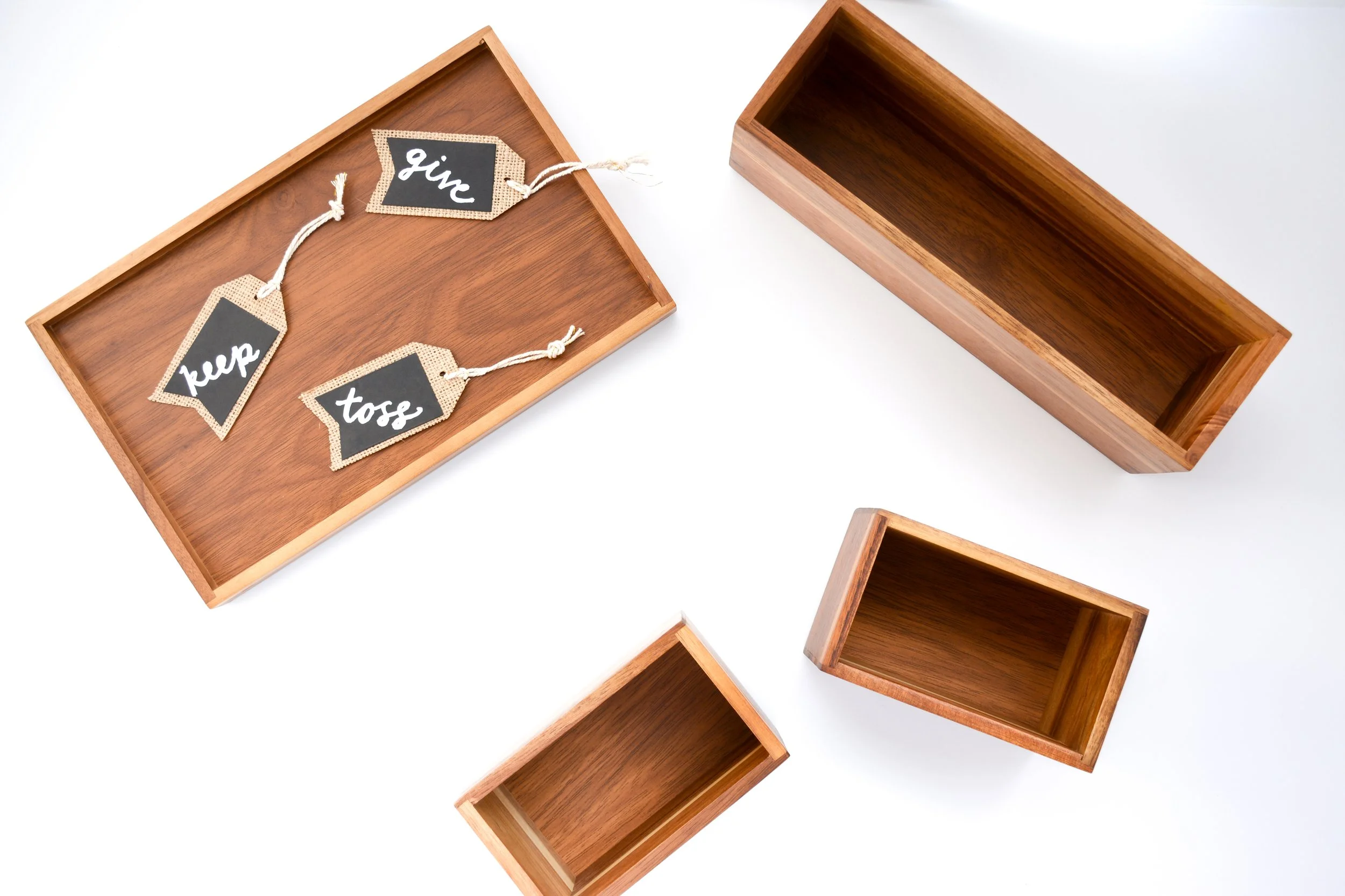 Wooden tray and boxes with signs saying keep, give and toss