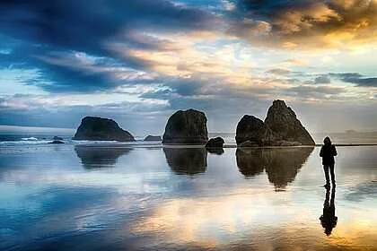 Thomas Knapp
"Stroll at Dawn" Photography 32"x48" $3000
Artwork Description
Low tide at dawn glistens in the early light as a beachgoer strolls among the towering outcroppings of rock. A pallet of vibrant colors shimmer on the wet sand as the tide re