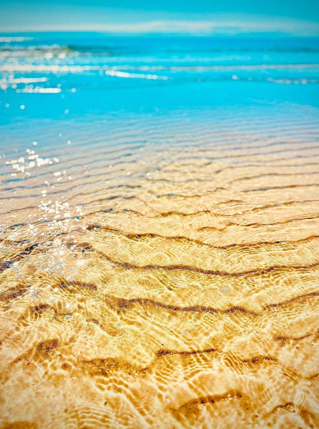 Jennifer Stephens "Where the Ocean Meets the Sky" 
Photography 
14 x 11"
$100
Artwork Description
This vibrant photograph bursts with the radiance of a perfect ocean day, where the crystal-clear blue water stretches playfully into the sky, blending w