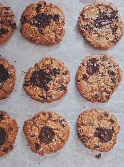 Nine chocolate chip cookies on parchment paper